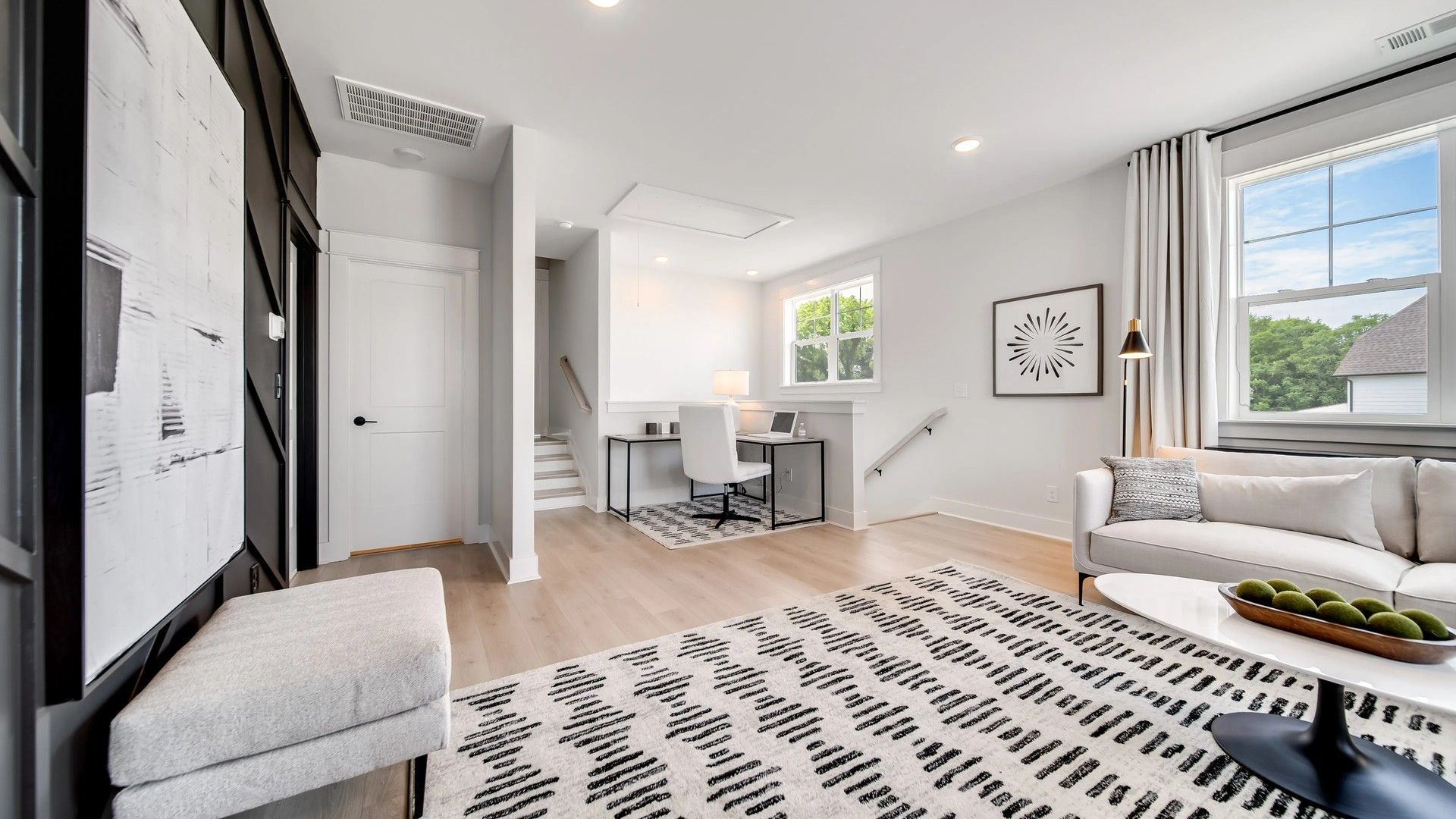 Experience luxury in Shelton Square's living room with expansive windows and refined contemporary design.