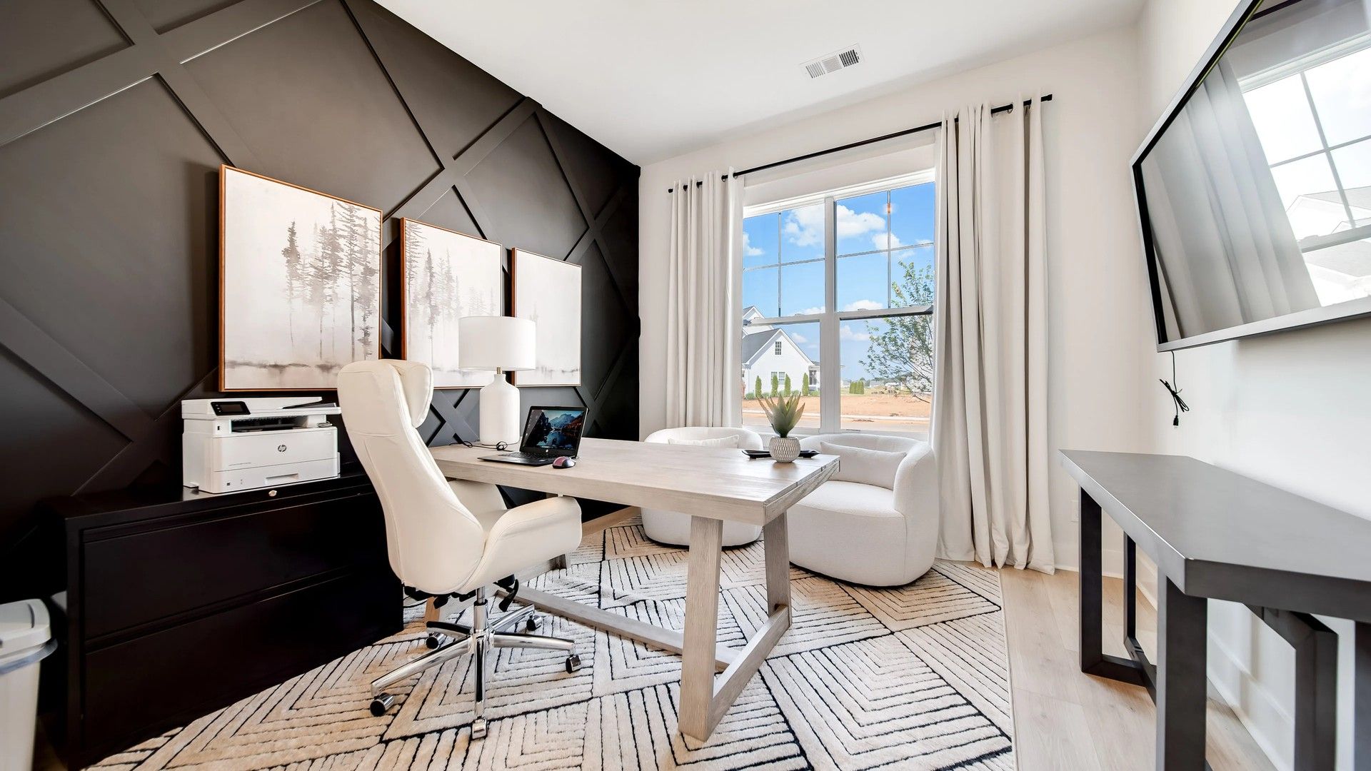 Experience sophistication with a bold black accent wall and airy design in Shelton Square.