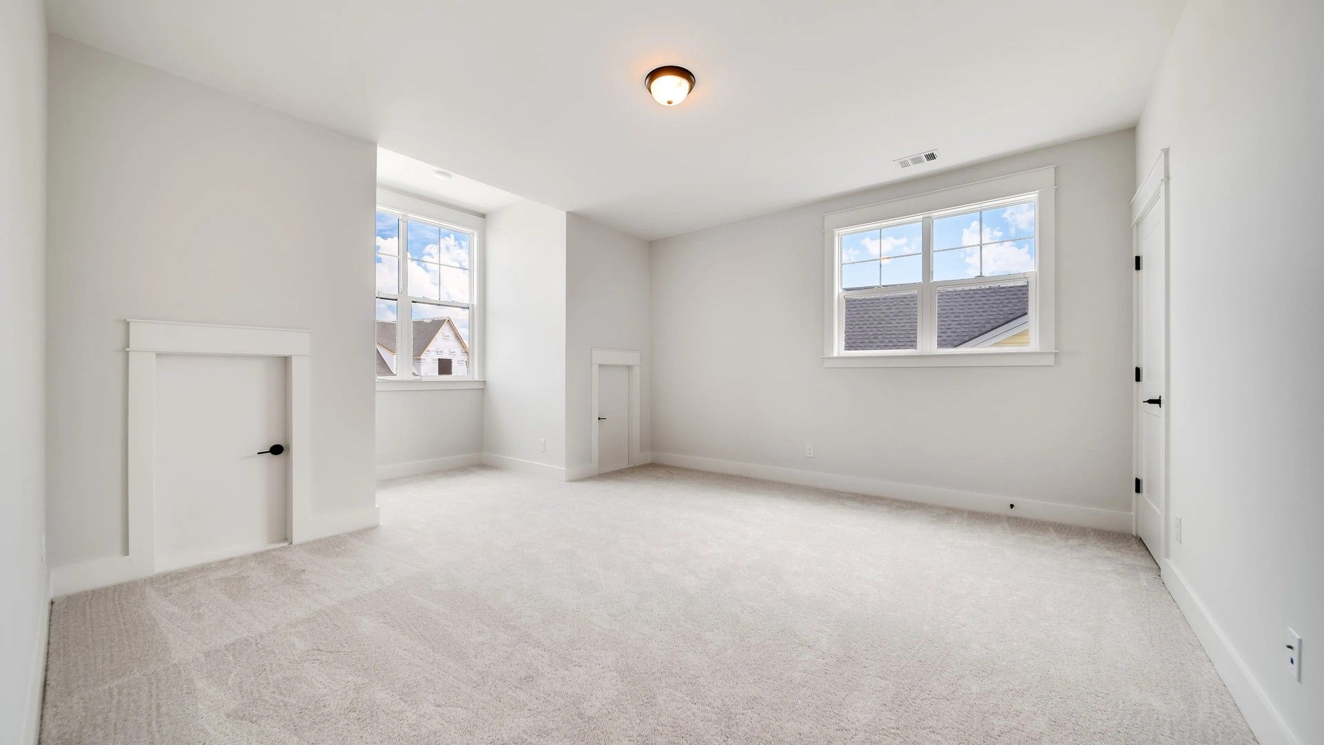 Expansive bedroom features plush carpeting and ample natural light in prestigious Shelton Square.