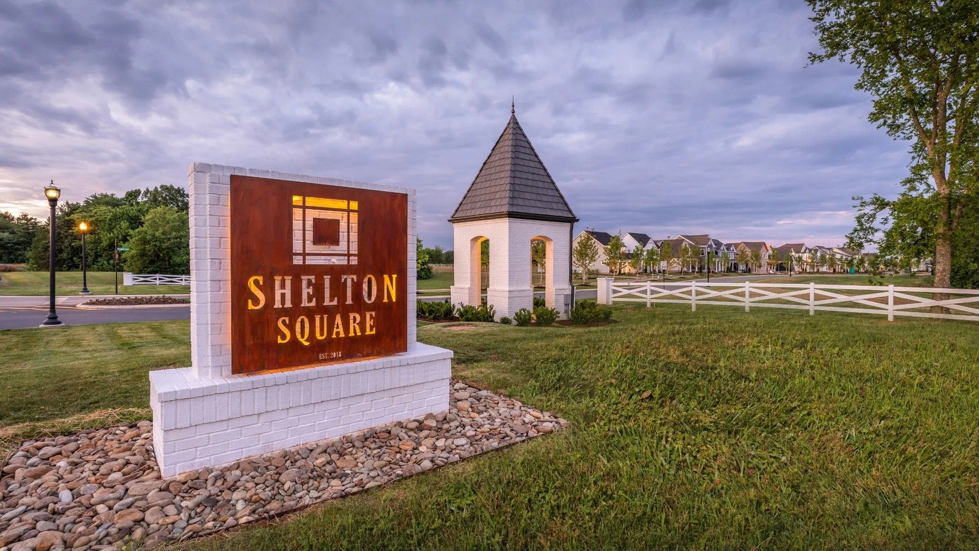 Shelton Square features a charming gazebo, artisan signage, and lush landscaping in this esteemed community.