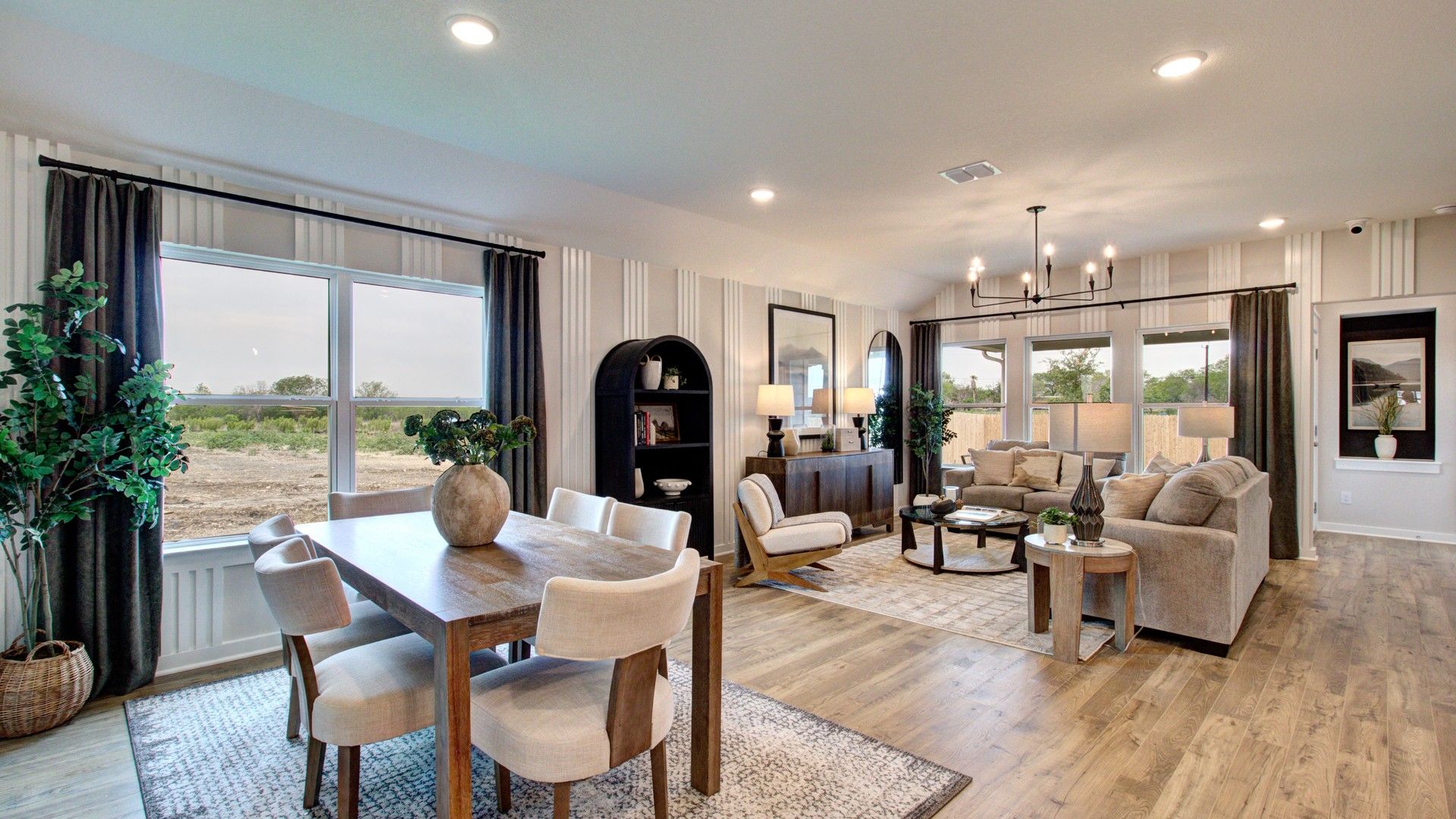 Distinctive chandelier and hardwood floors enrich this Prairie Green home's luxurious open-plan ambiance.