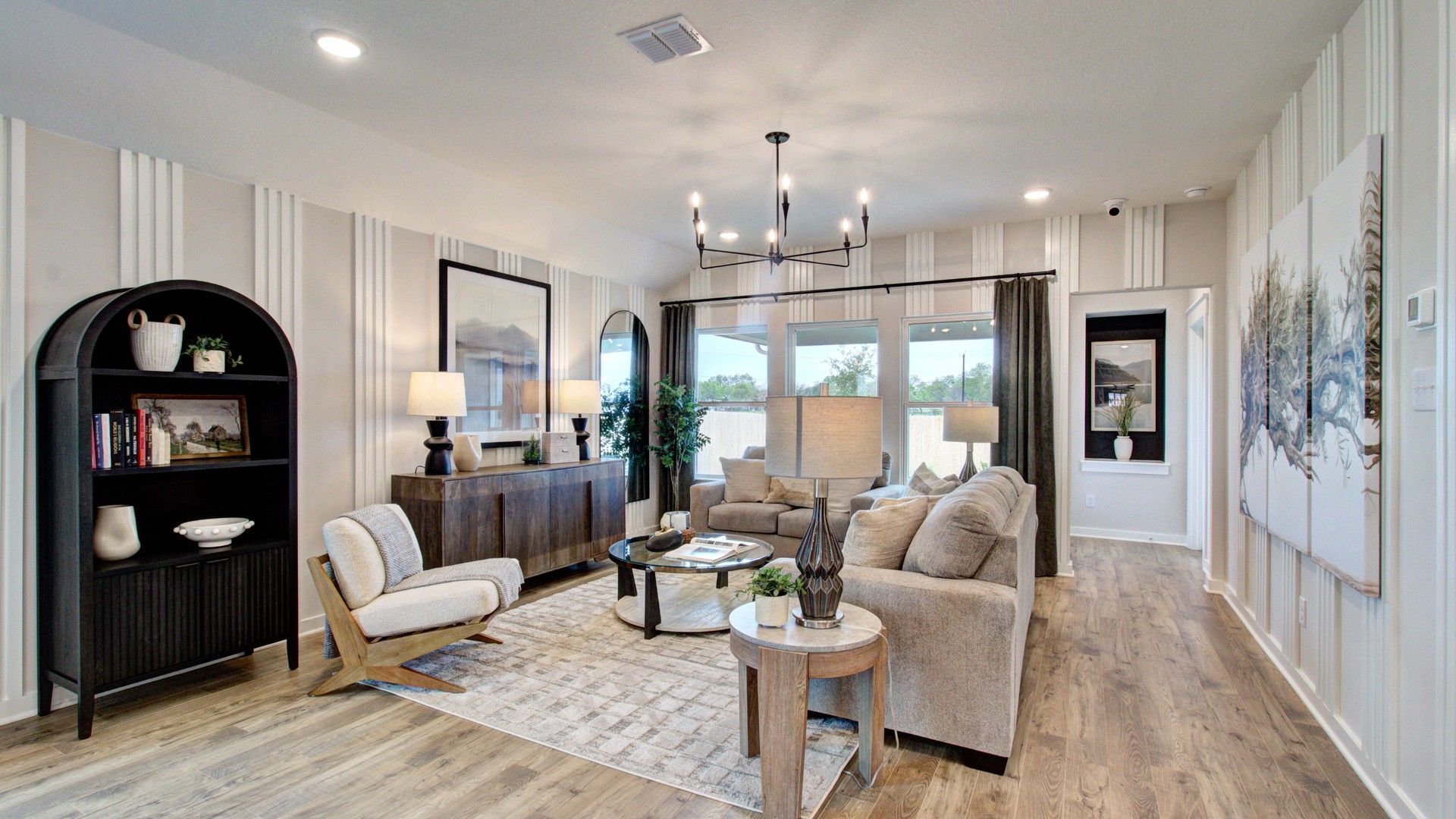 Experience refined living with wood flooring, stylish chandelier, and ample natural light in Prairie Green.