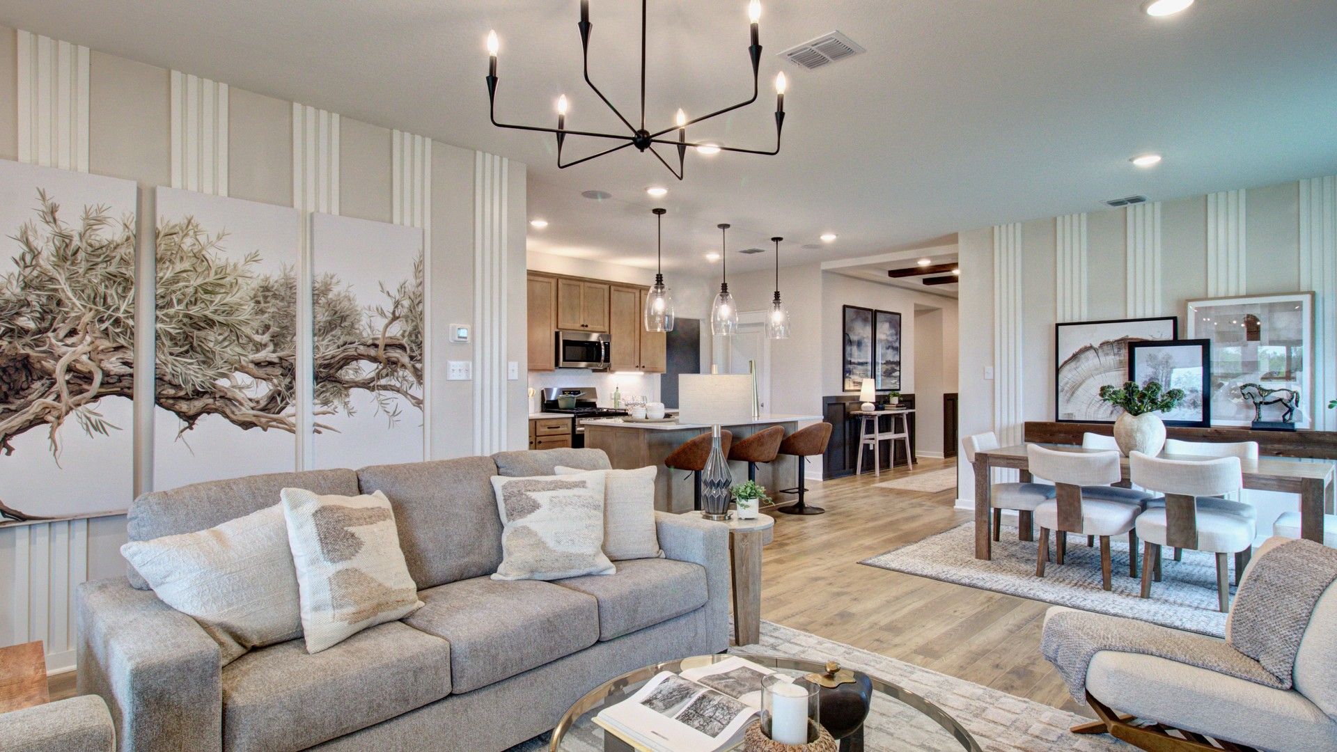 Sophisticated open layout with a striking chandelier, art accents, and premium finishes in Prairie Green community.