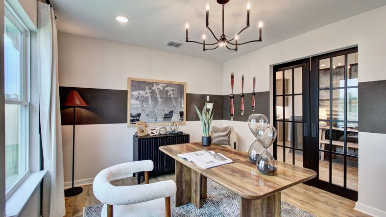Experience refined elegance with sleek glass doors and designer chandelier in Prairie Green's office space.