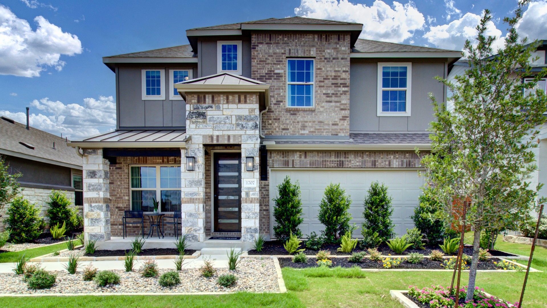 Elegant Meyer Ranch home features a stately brick facade, stone accents, and pristine landscaping for luxury living.