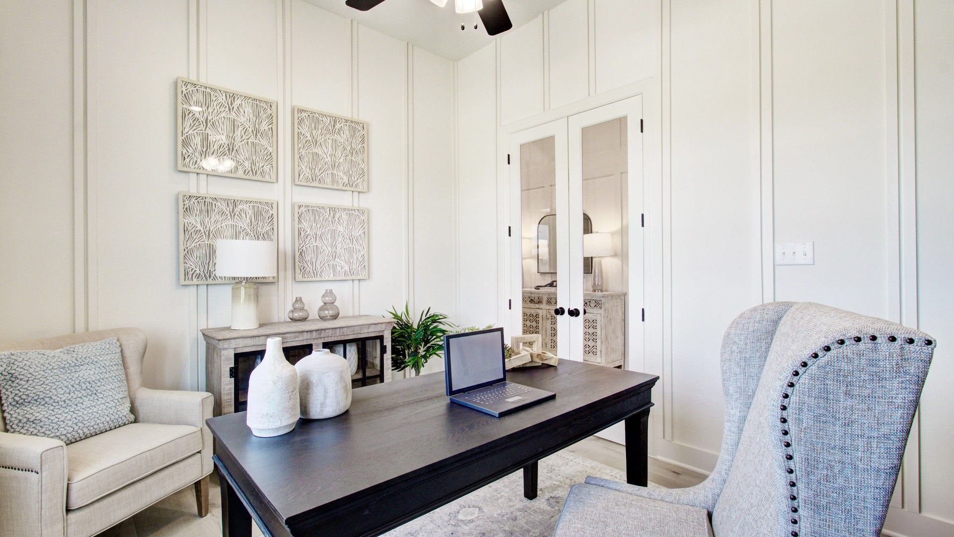 Sophisticated paneling and exquisite decor enhance this Veranda community home office.