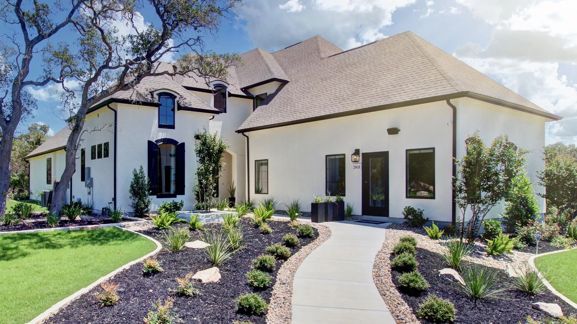 This Verandas at the Rim home features exquisite dormer windows and elegant landscaping, offering unmatched luxury.