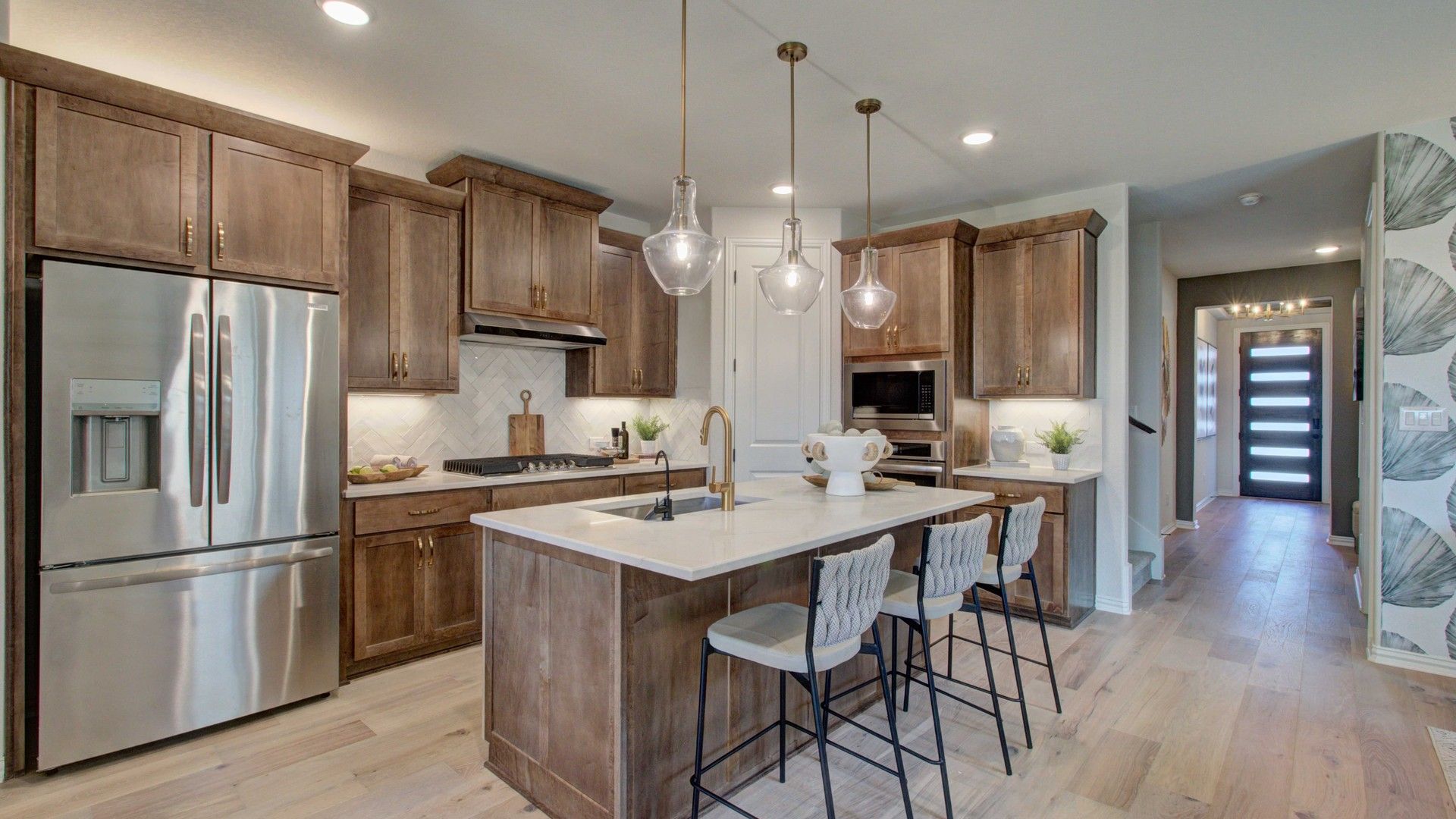 Exquisite Meyer Ranch kitchen features rich wood cabinets and elegant pendant lighting, enhancing luxury living ambiance.
