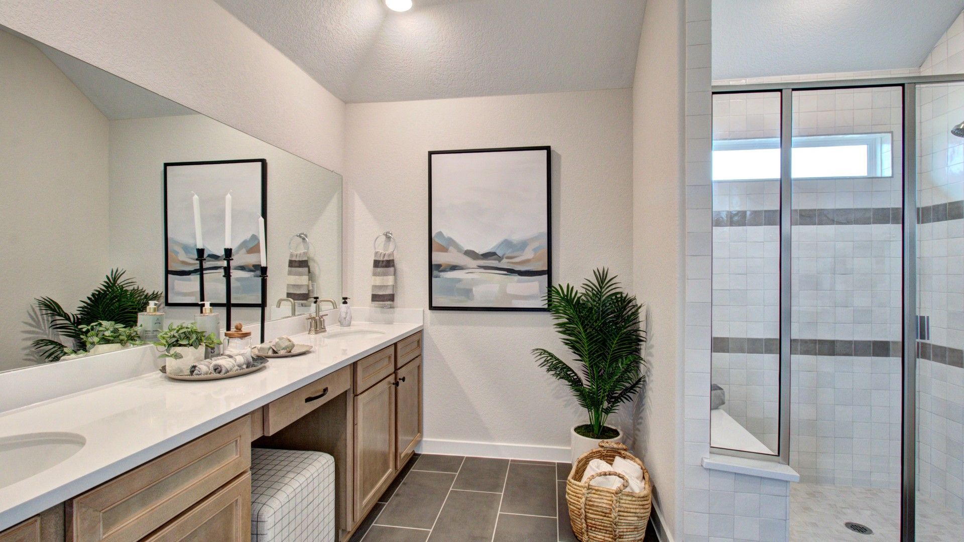 Experience elegance with dual sinks, premium wood cabinetry, and pristine glass shower at Prairie Green.
