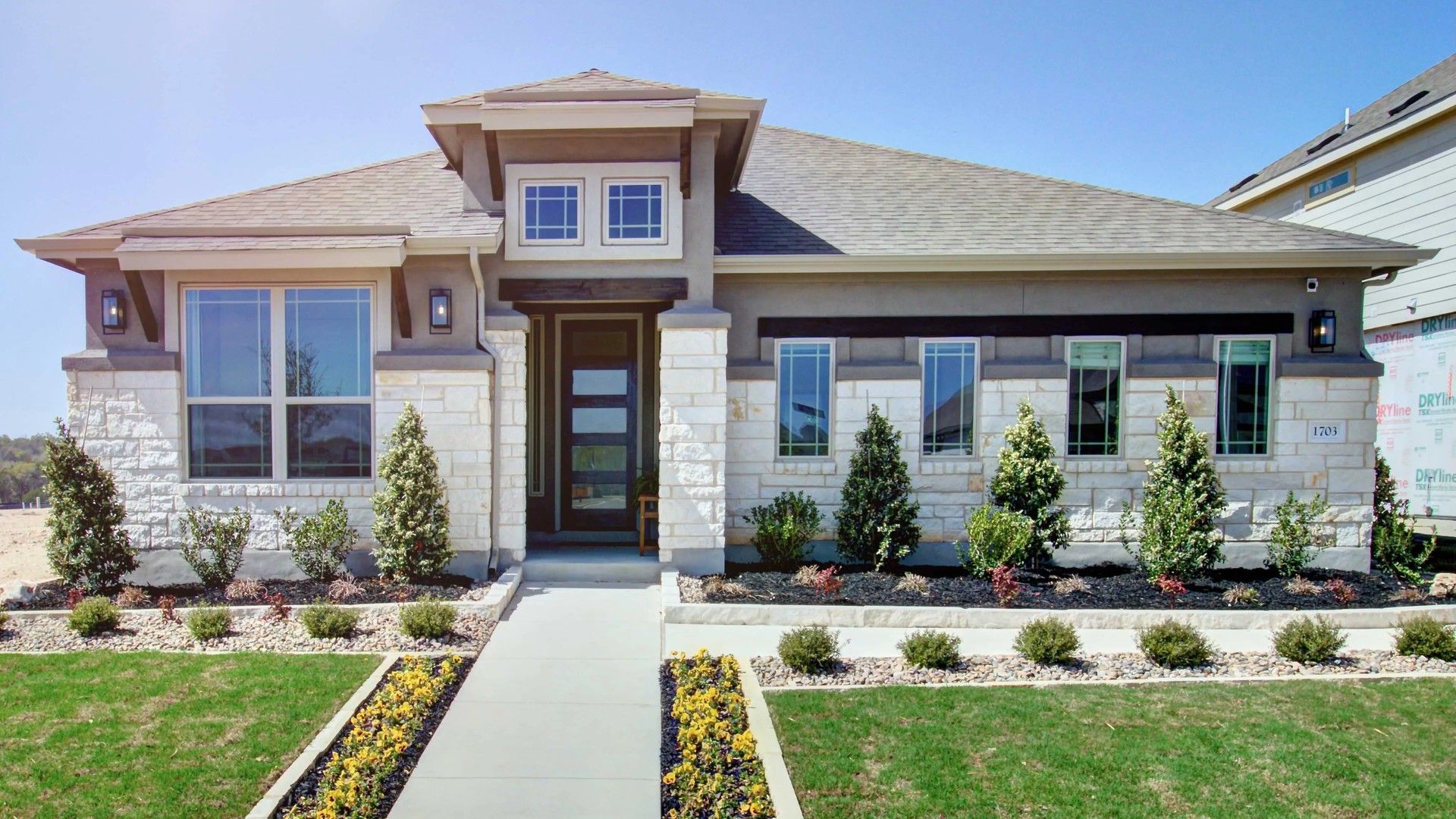 Elegant stone facade, expansive windows, and pristine landscaping define this luxurious Meyer Ranch home.