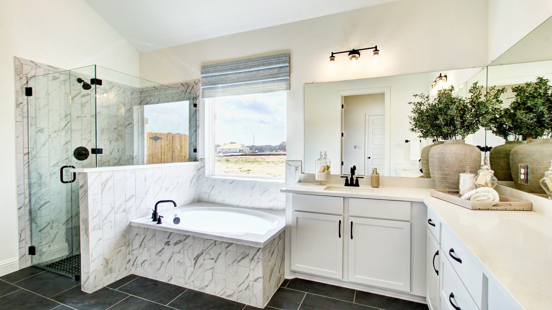 Elegant glass shower and marble tiles create a luxurious ambiance in this Veranda home.