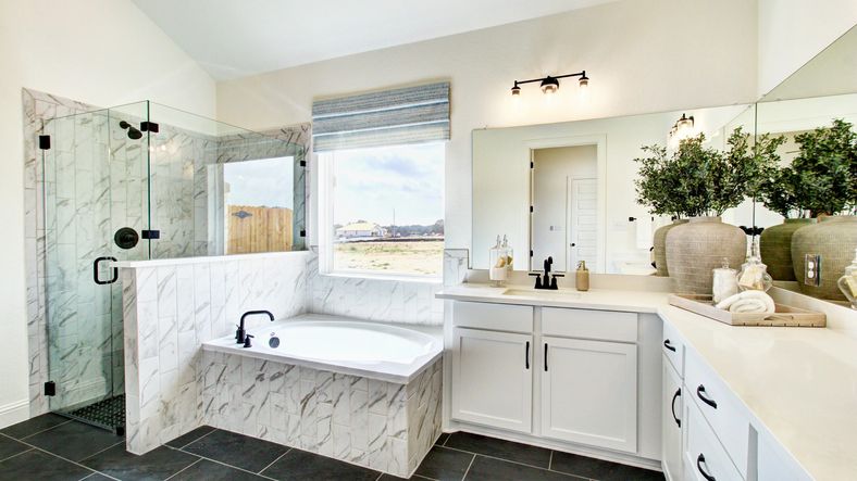 Elegant glass shower and marble tiles create a luxurious ambiance in this Veranda home.