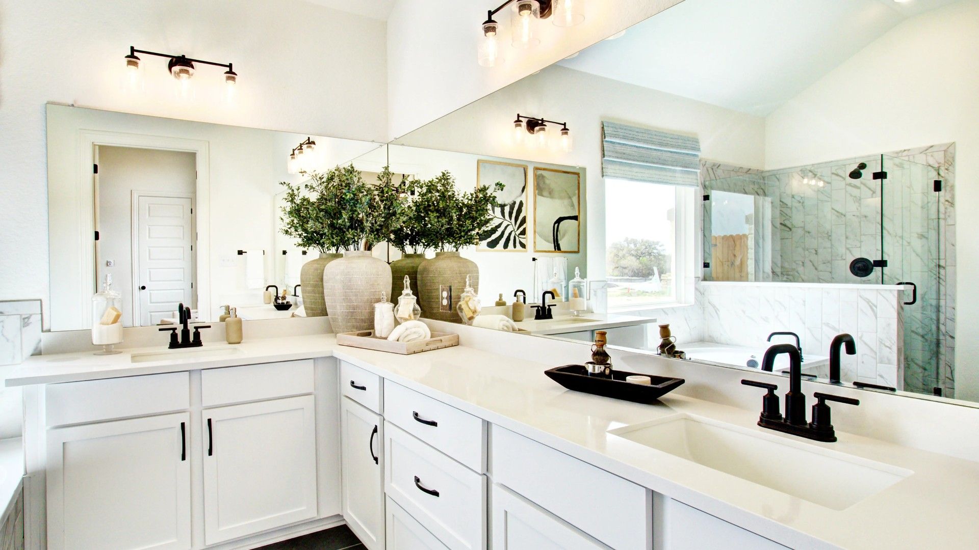 Stunning double vanity, sleek black fixtures, marble shower–elevate your mornings in Veranda.