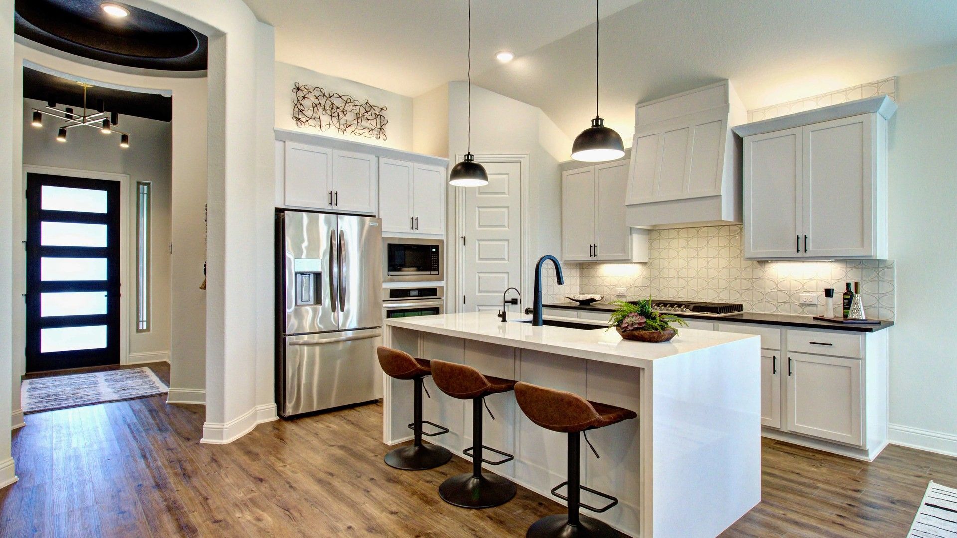 Bask in luxury with quartz countertops, a grand island, and sophisticated lighting in Meyer Ranch.