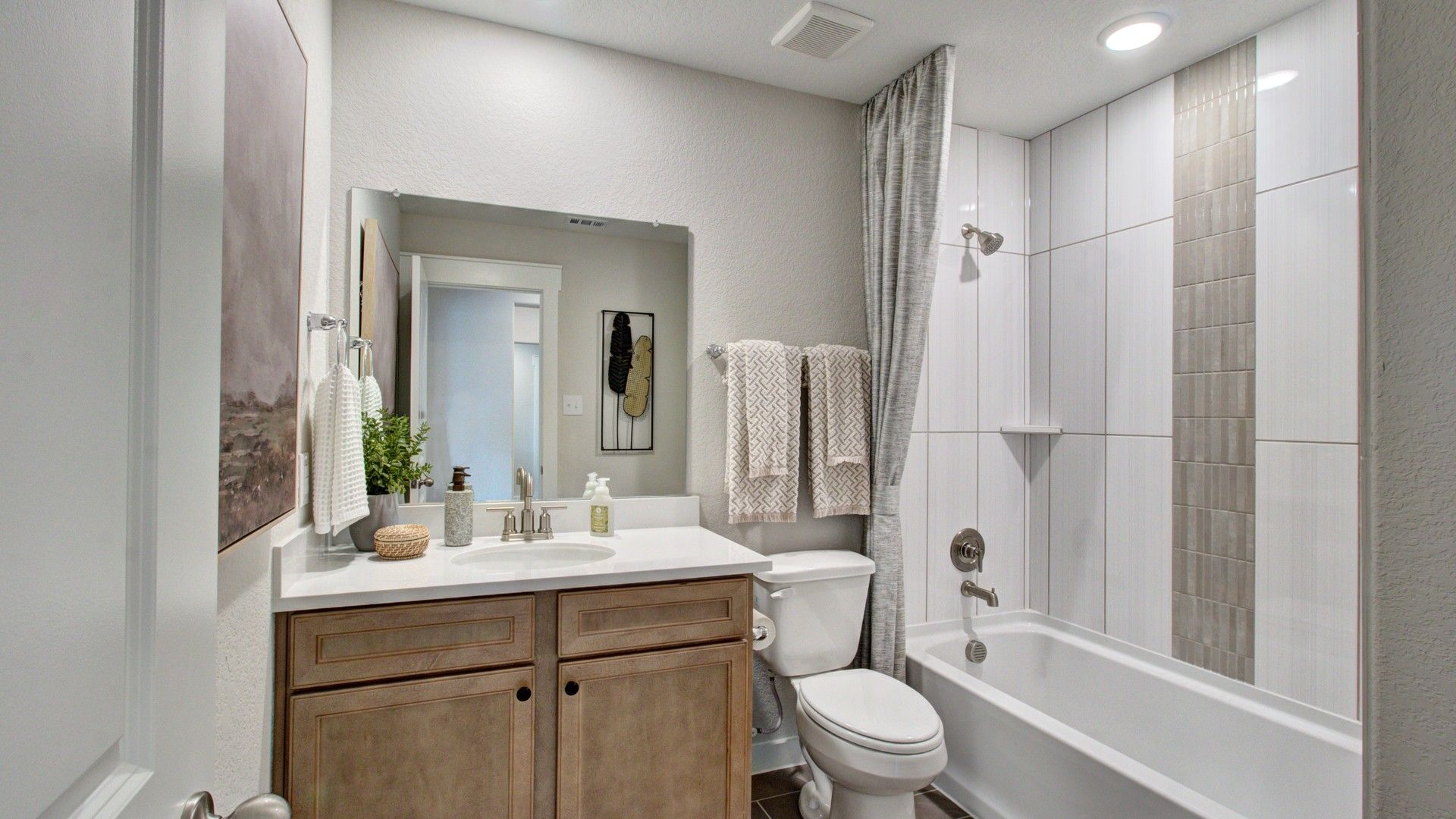 Experience refined luxury with sleek tile detail and custom wood cabinetry in Prairie Green.