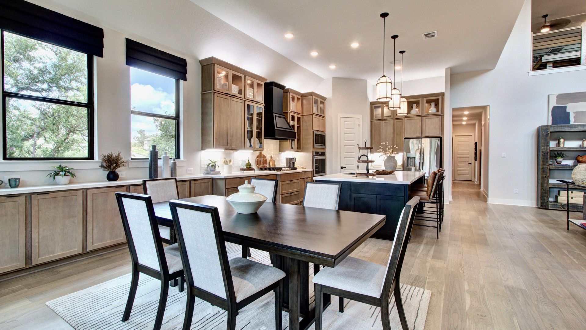 Elegant kitchen with custom wood cabinets, expansive island, and chic pendant lights in Verandas at the Rim.