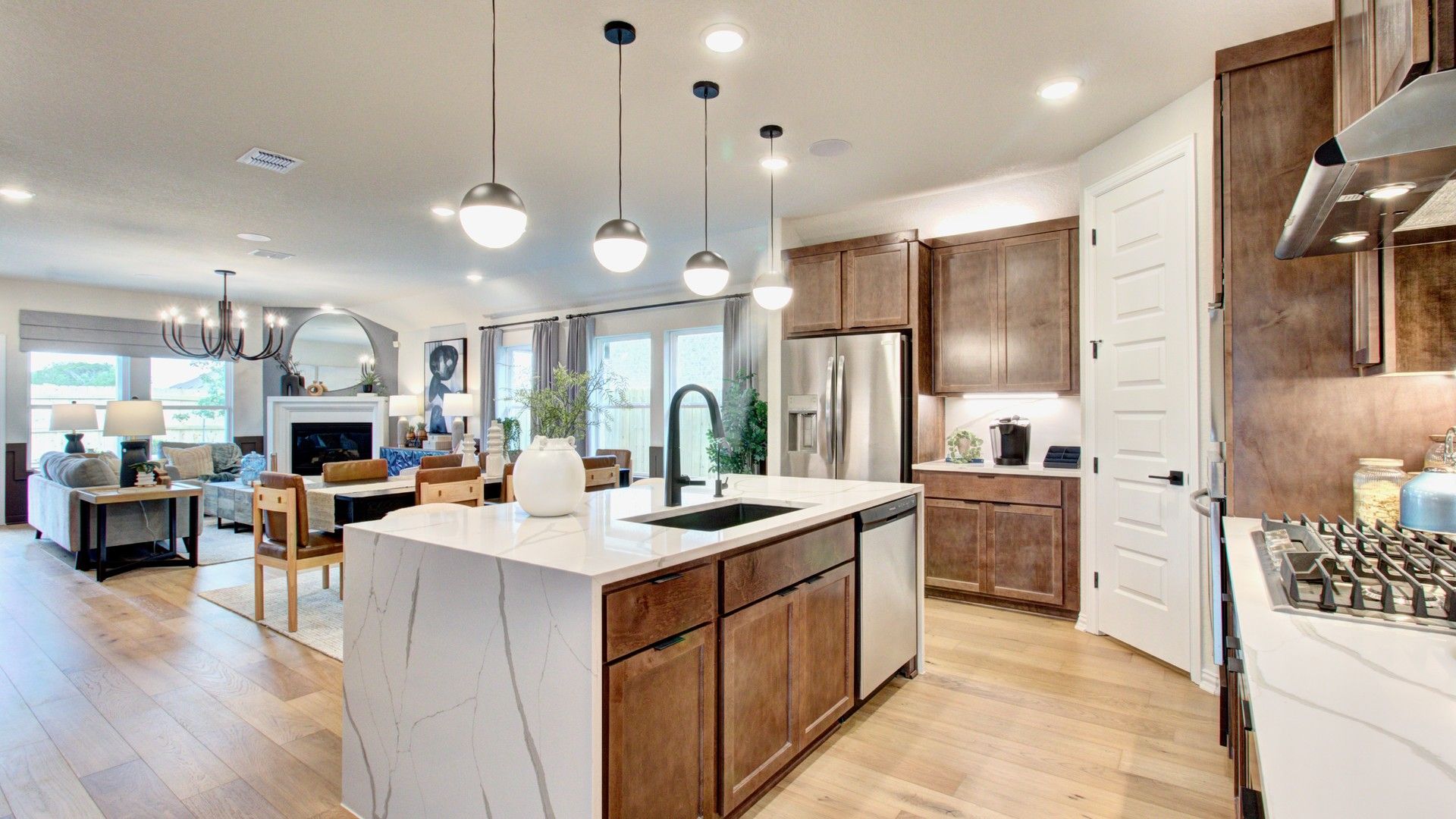 Experience luxury with top-tier marble island, rich wood cabinetry, and sleek design in Sunflower Ridge.