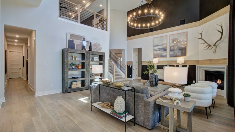 Exquisite high ceilings, polished wood floors, and grand chandelier exemplify luxury living at Verandas at the Rim.