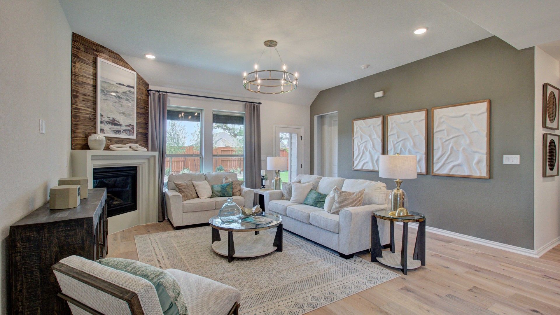 Luxurious Meyer Ranch living room boasting sleek fireplace, modern chandelier, and expansive windows.