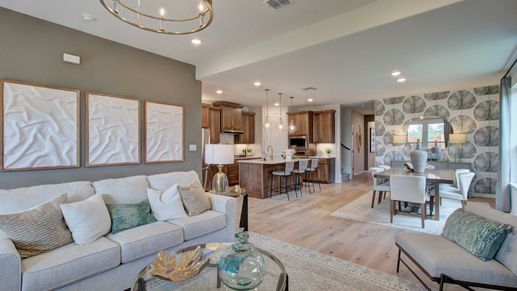 Luxurious open layout features exquisite wood flooring, modern kitchen, and elegant chandelier in Meyer Ranch, Enclave.