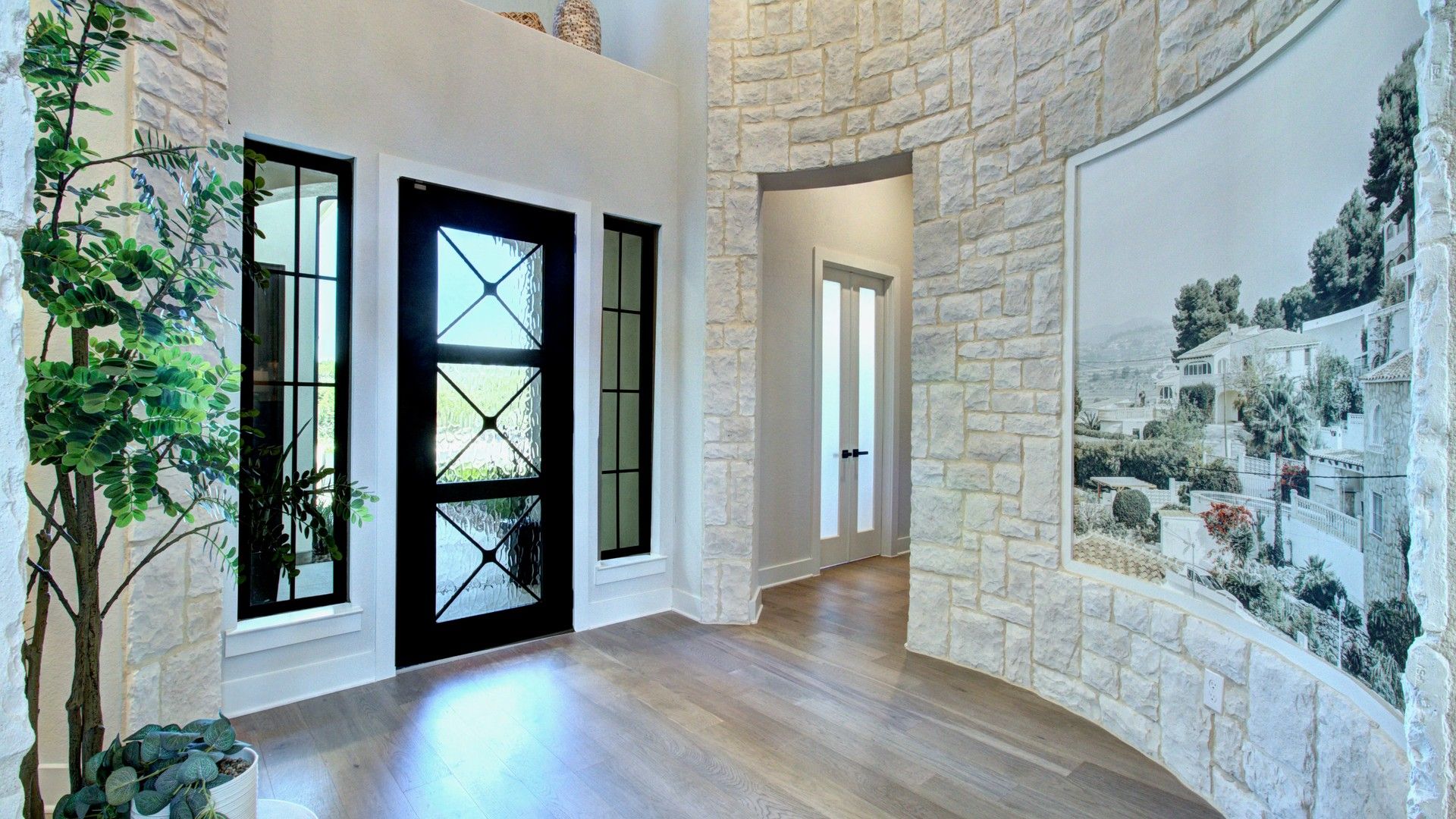 Stunning stonework and exquisite flooring elevate this Verandas at the Rim foyer to unmatched luxury.