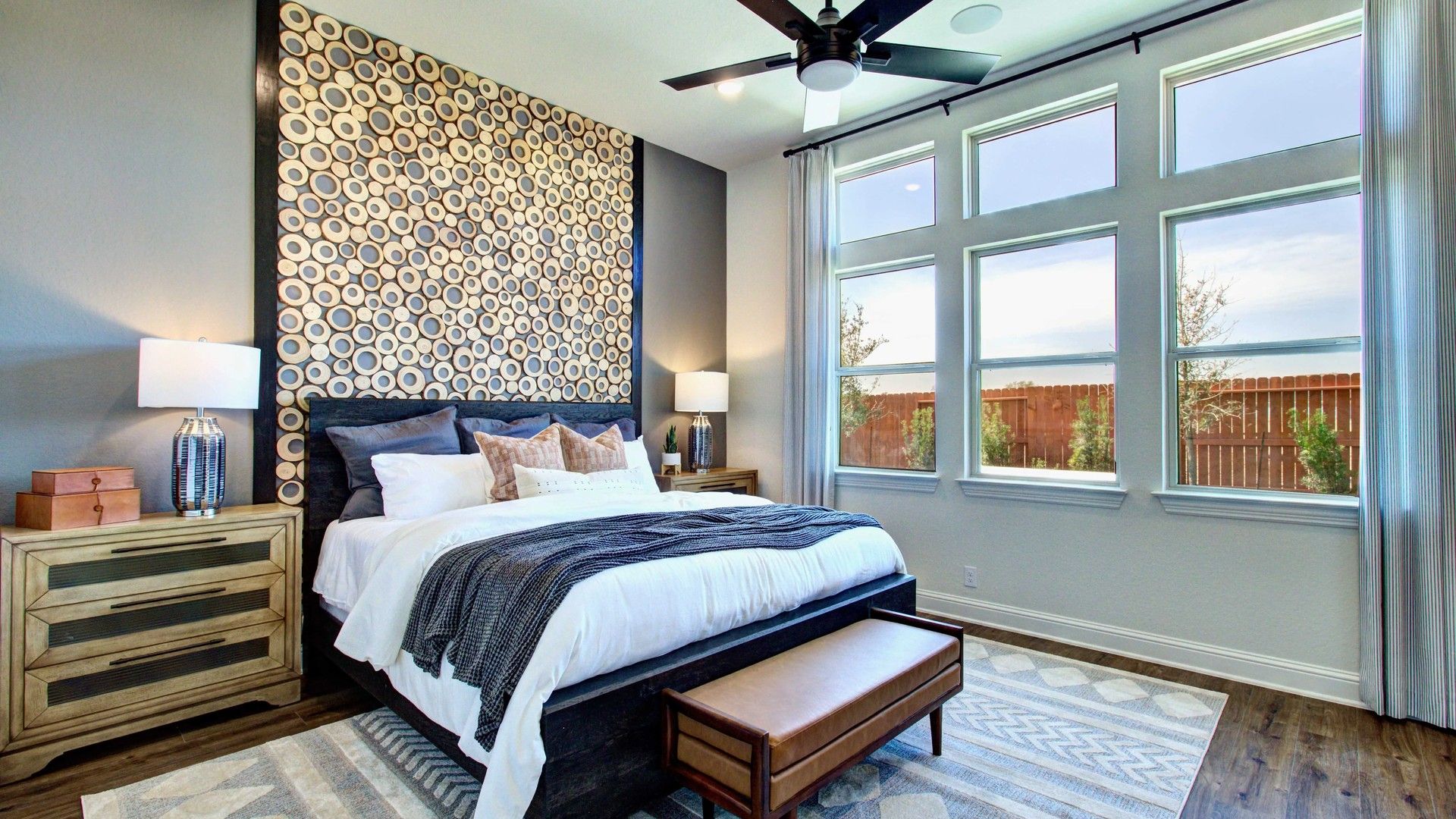 Elegant wood accent wall complements expansive windows and upscale decor in Meyer Ranch, Texas.