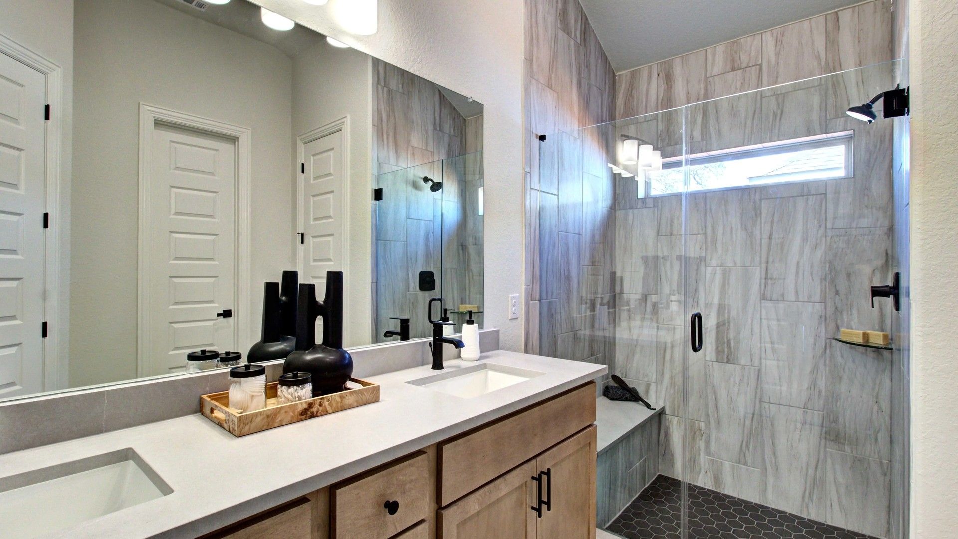 Experience opulence with dual sinks, elegant marble texture, and a glass shower at Meyer Ranch.