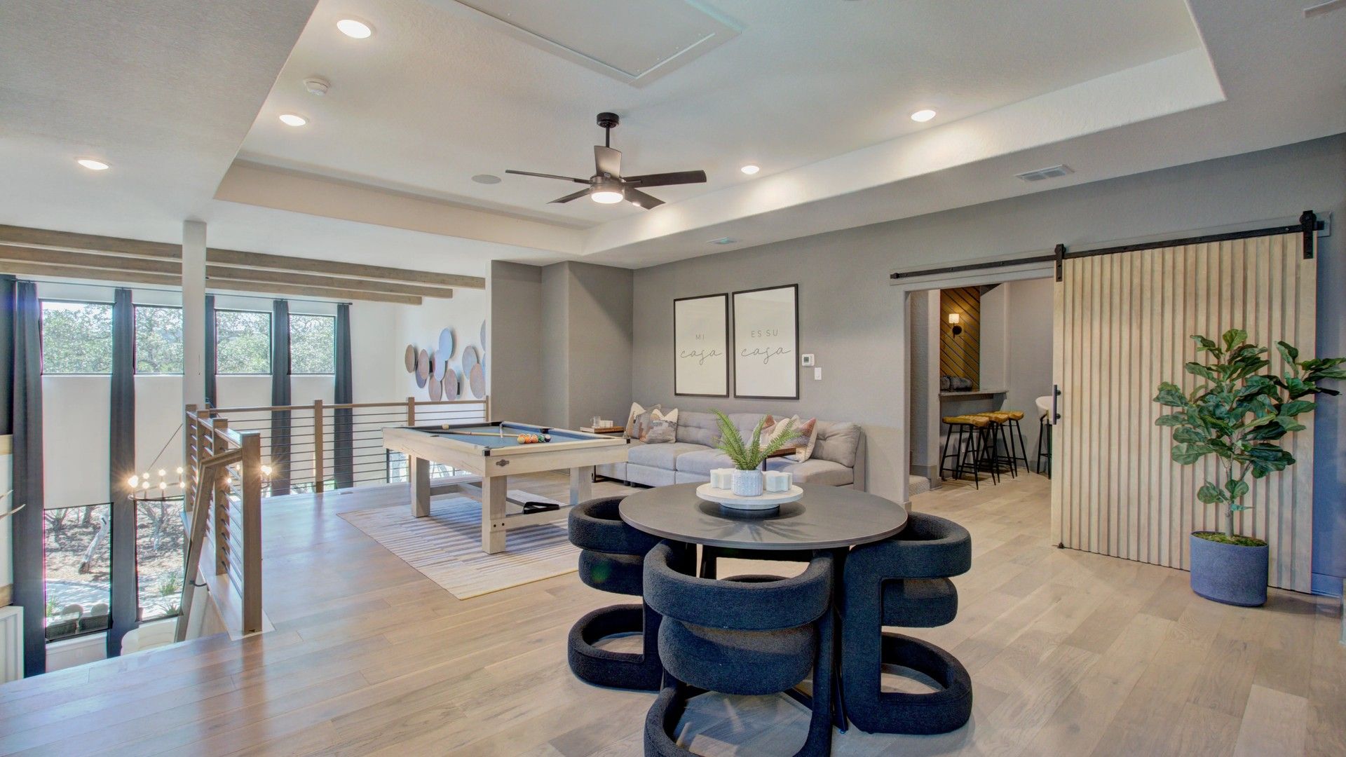 Elegant open-concept with sleek wood accents and expansive windows in Verandas at the Rim, San Antonio.
