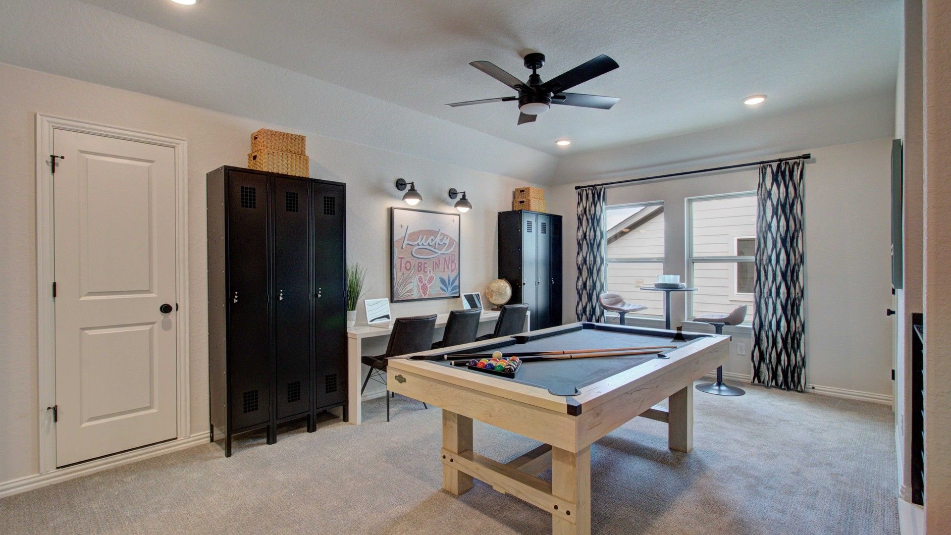 Elegant game room with modern fixtures and plush carpet in exclusive Meyer Ranch.