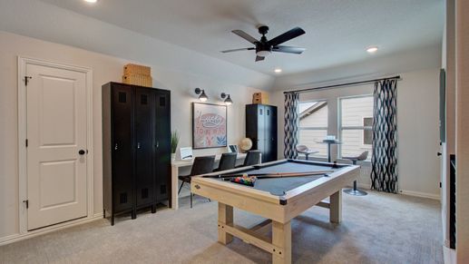 Elegant game room with modern fixtures and plush carpet in exclusive Meyer Ranch.