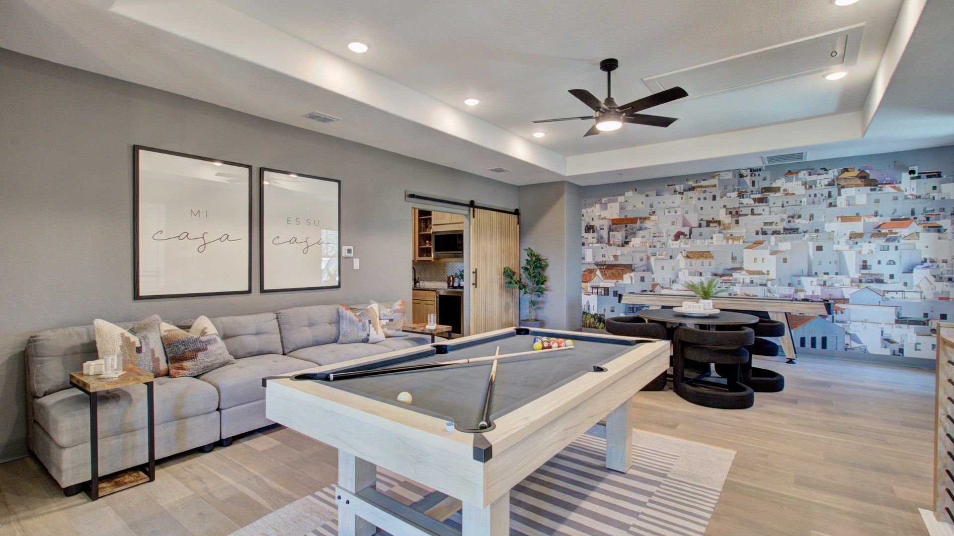 Sleek pool table and custom wall art enhance this luxury game room at Verandas at the Rim.