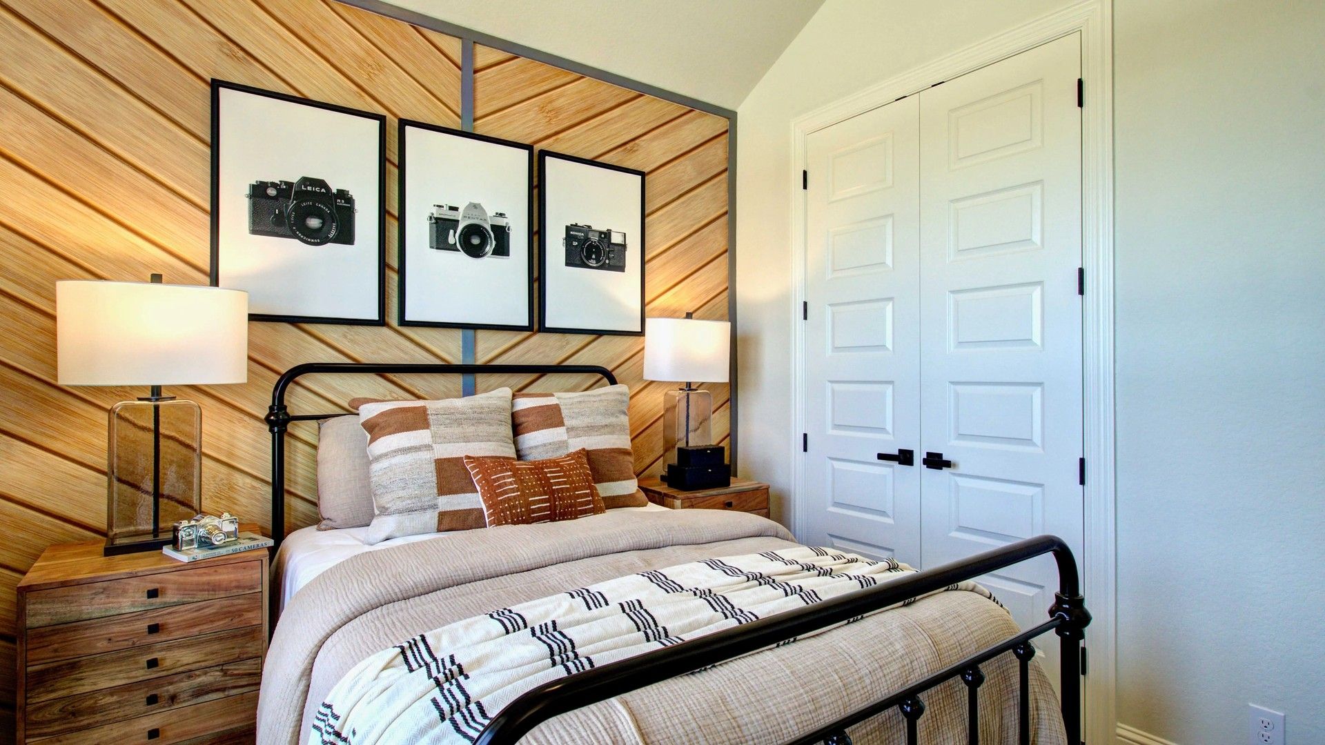 Meyer Ranch bedroom with unique wood chevron wall, elegant metal bed, and chic decor.
