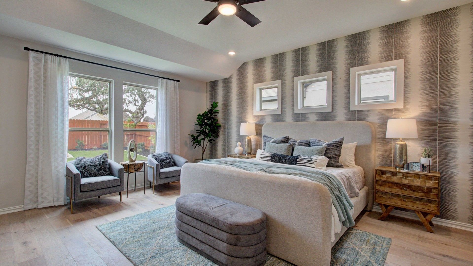 Indulge in this Meyer Ranch bedroom's modern wallpaper, sleek furniture, and expansive windows for ultimate comfort.