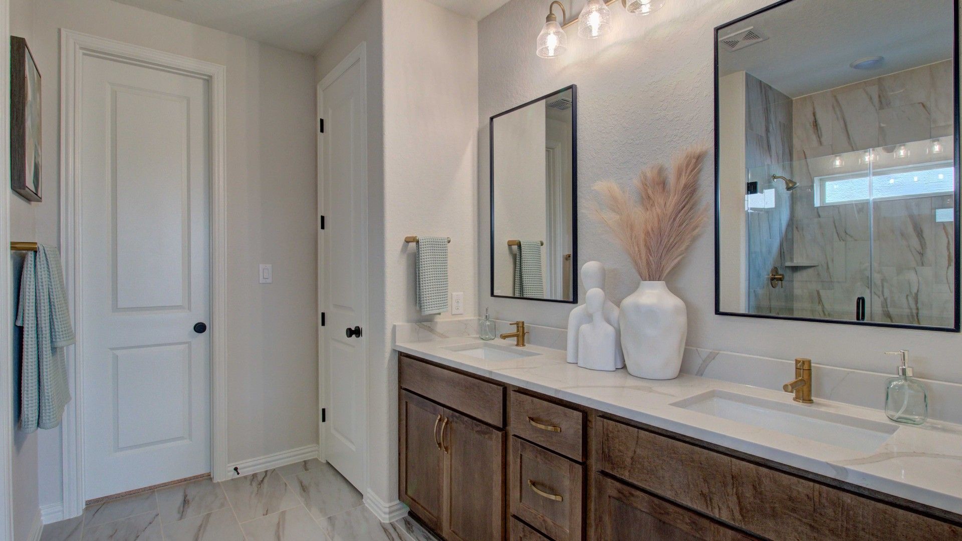 Sophisticated double vanity with gold fixtures and marble detailing in Meyer Ranch, elevating luxury living.