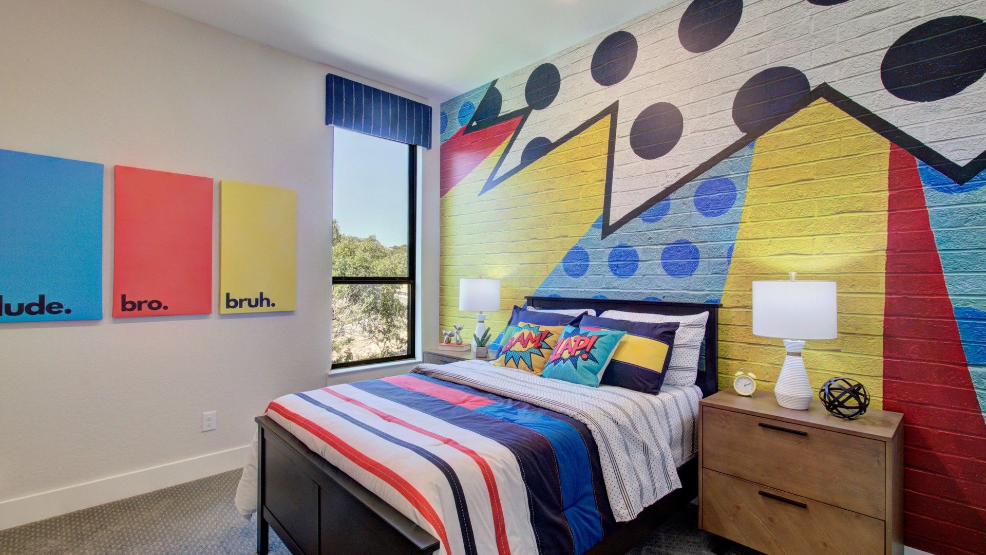 Bold pop art mural accents this stylish Verandas at the Rim bedroom. Ultra-modern design with natural light.