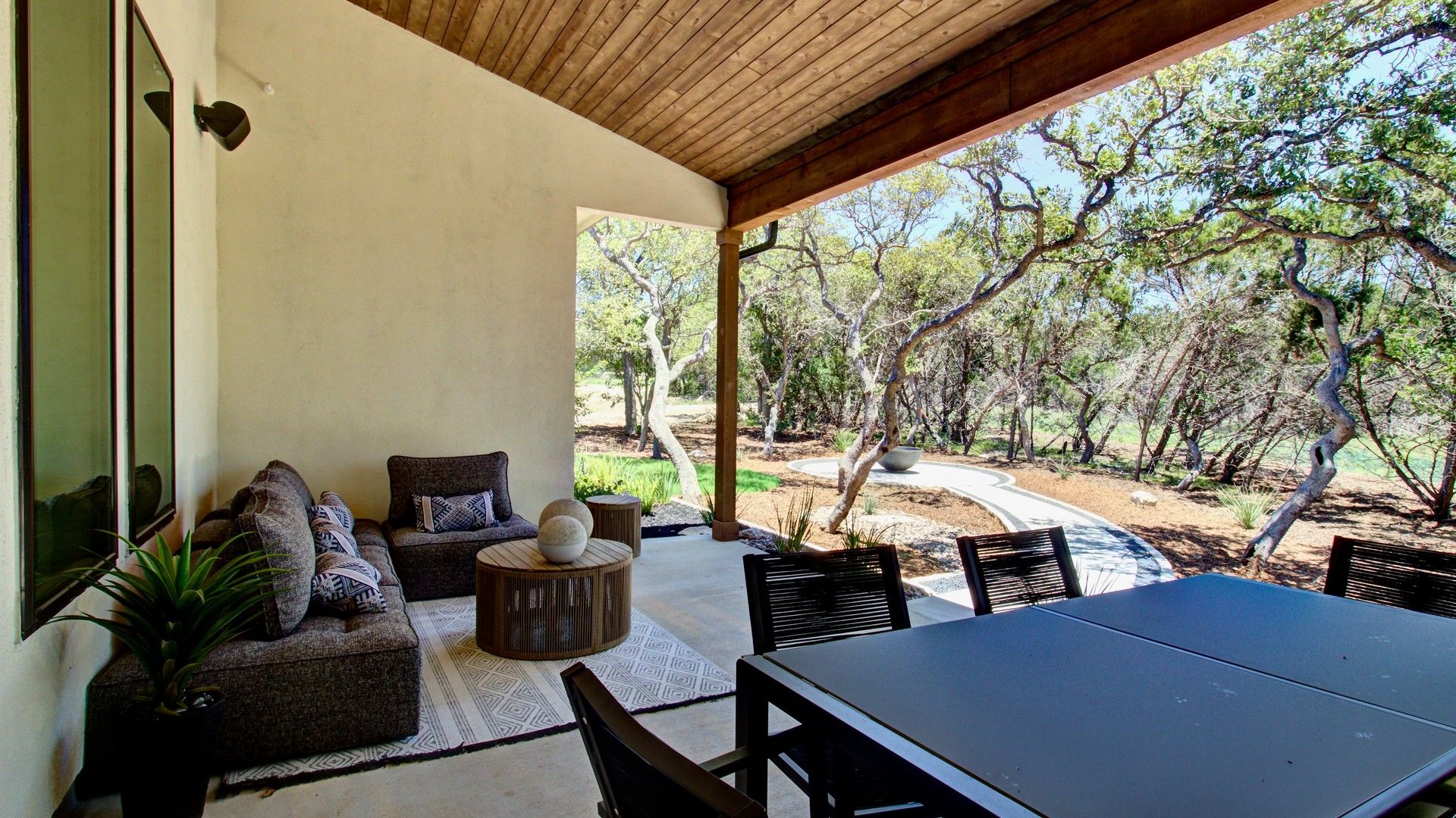 Elegant covered patio with sleek wood accents and chic outdoor furniture at Verandas at the Rim.
