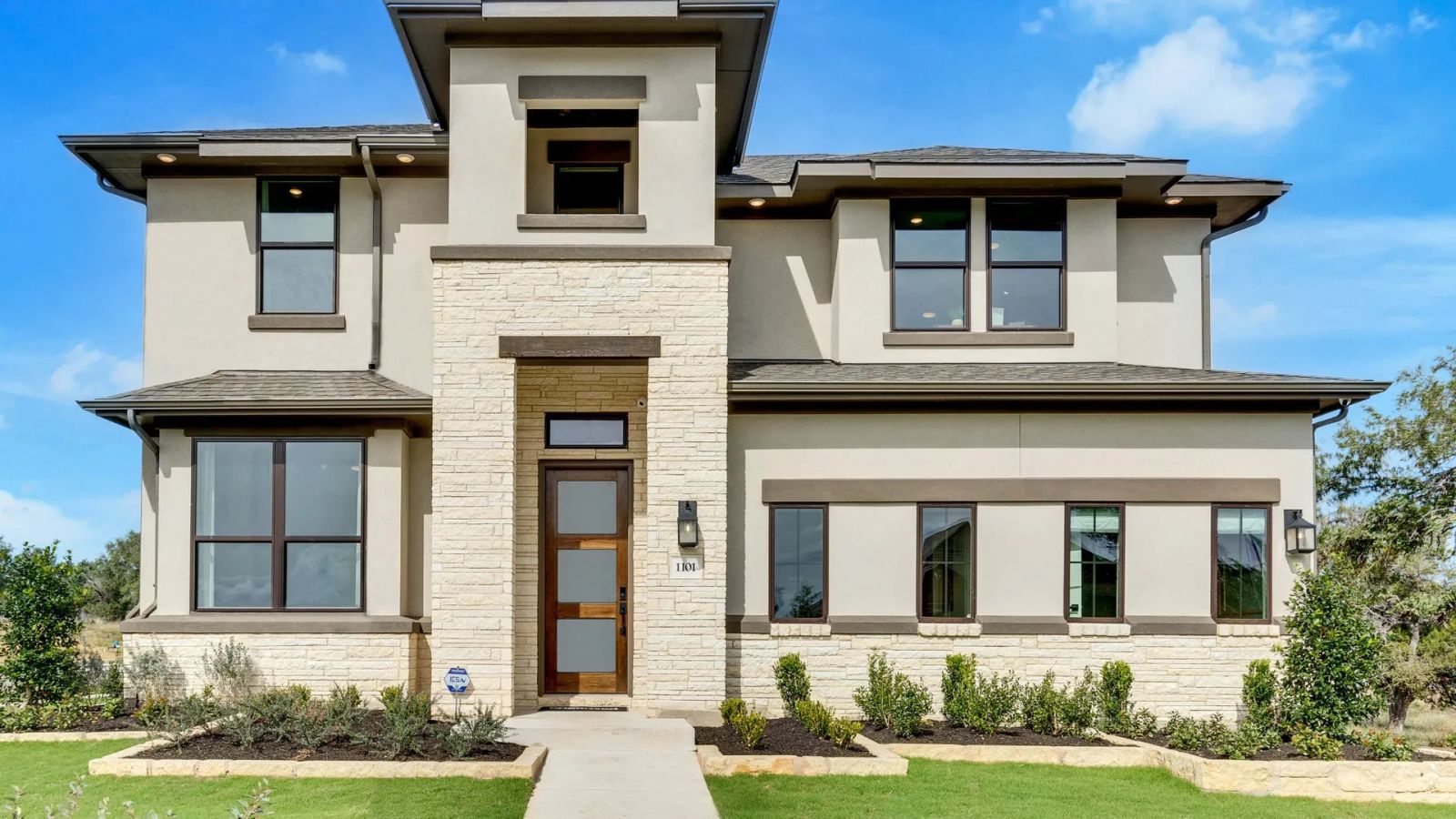 Elegant two-story home featuring stone accents and sleek stucco facade in San Gabriel, Texas.