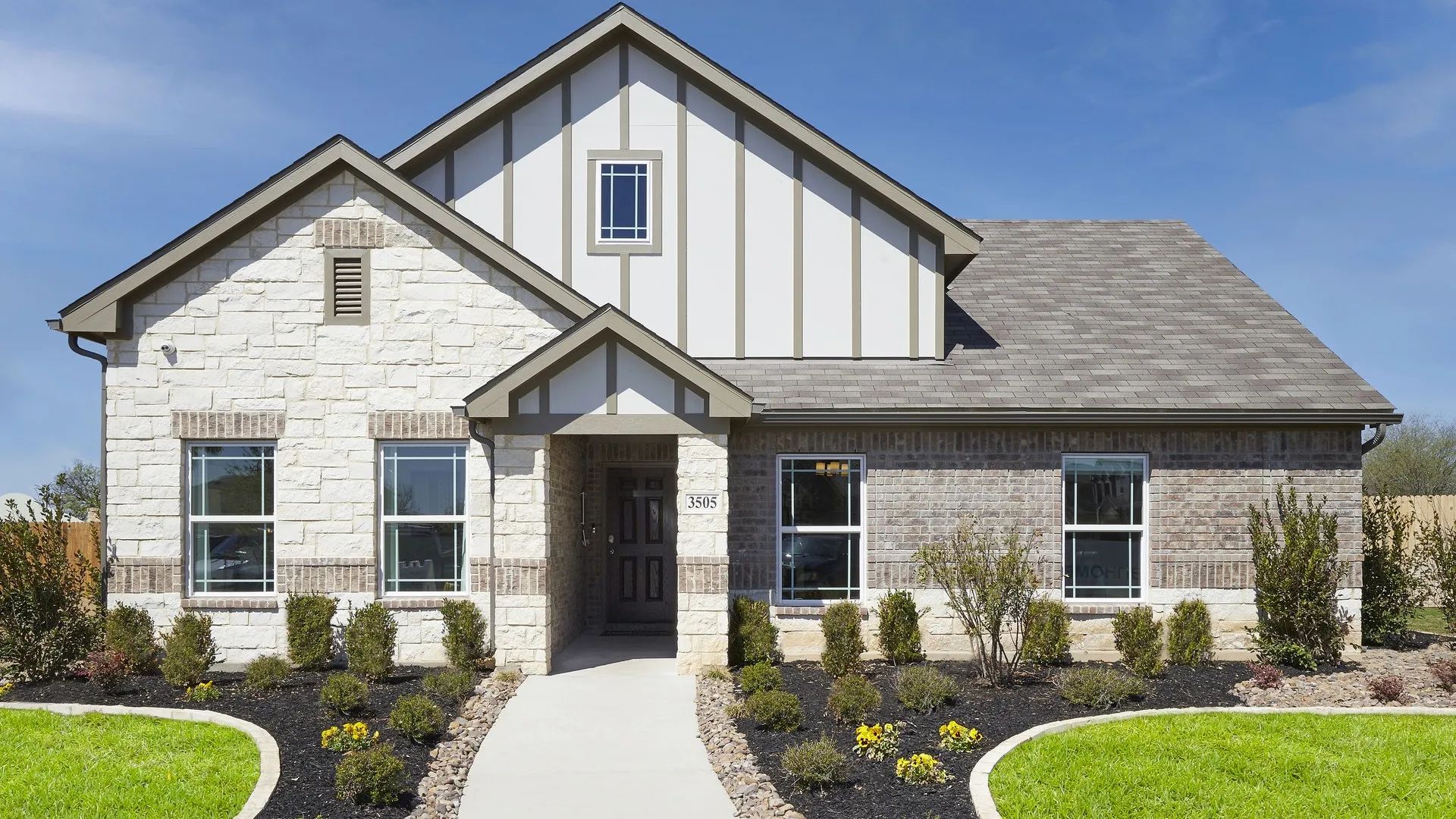 Exquisite stone and brick facade with spacious windows at Sky Ridge, Texas. Stunning architectural elegance.