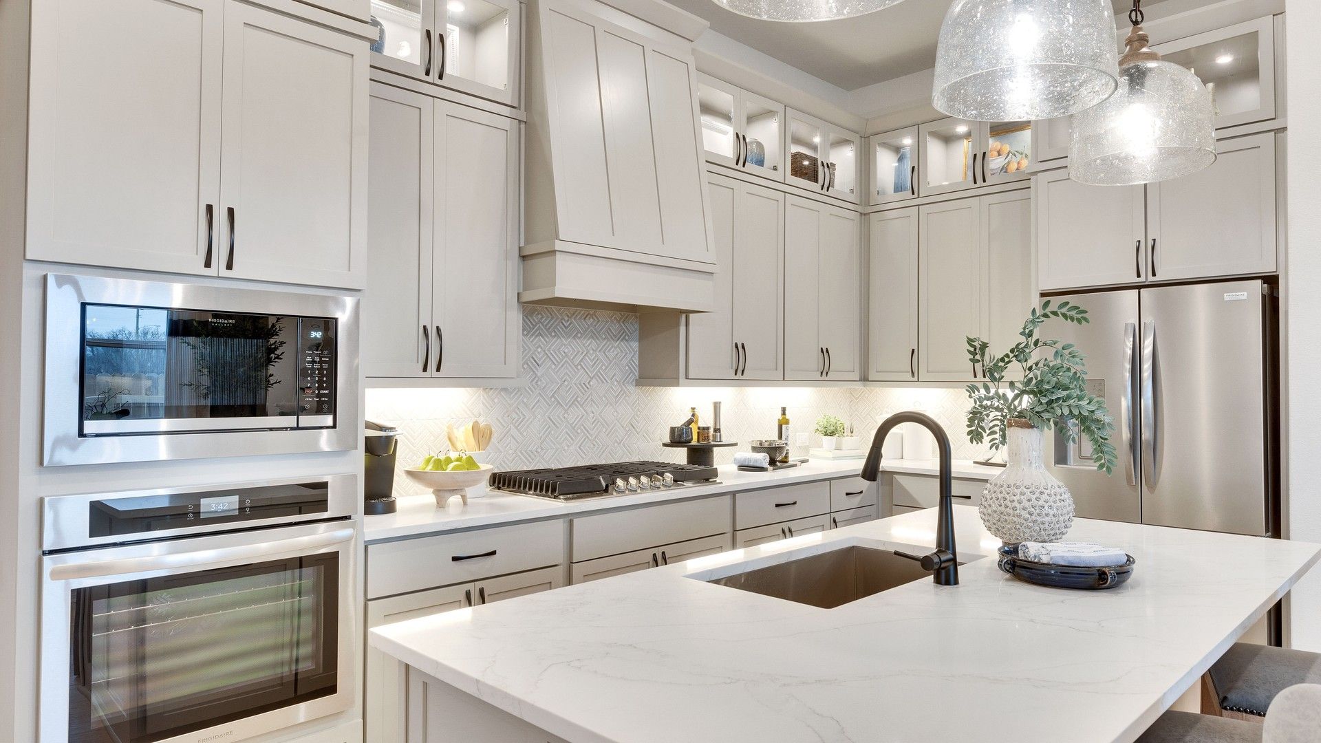 Luxurious Spring Creek kitchen featuring marble countertops and chic stainless appliances.