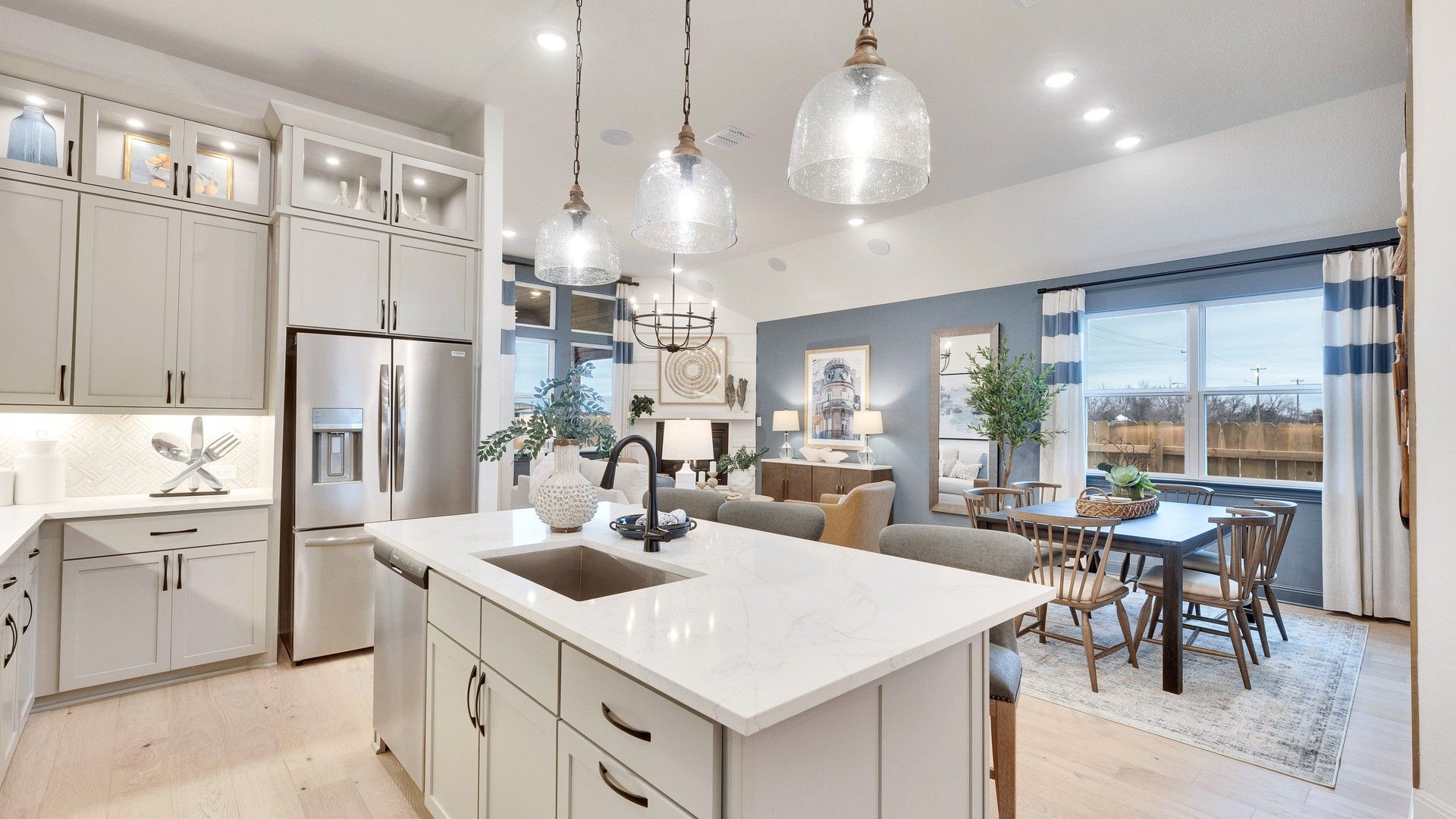 Spring Creek home with marble-topped island, custom cabinetry, and designer pendant lighting.