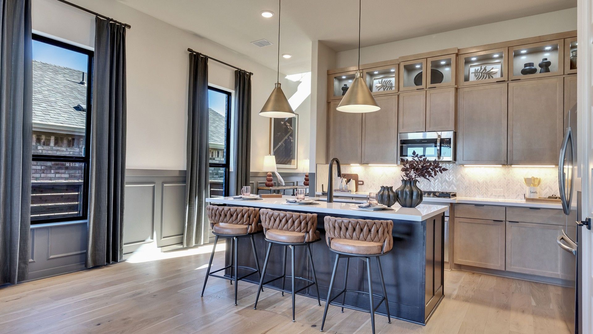 Luxurious custom cabinets and herringbone backsplash elevate this Flora kitchen.