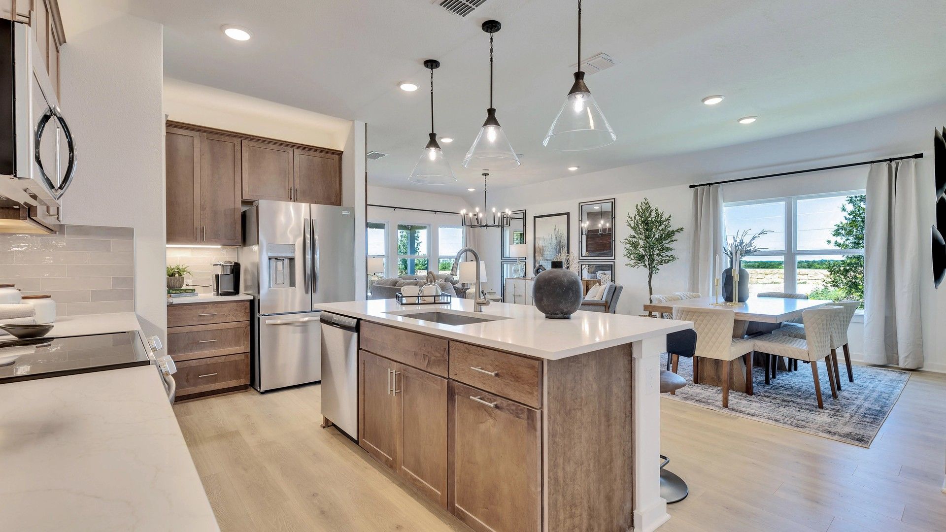 Sleek wood cabinetry and spacious island enhance the elegance of Hunters Glen's upscale kitchen and dining area.