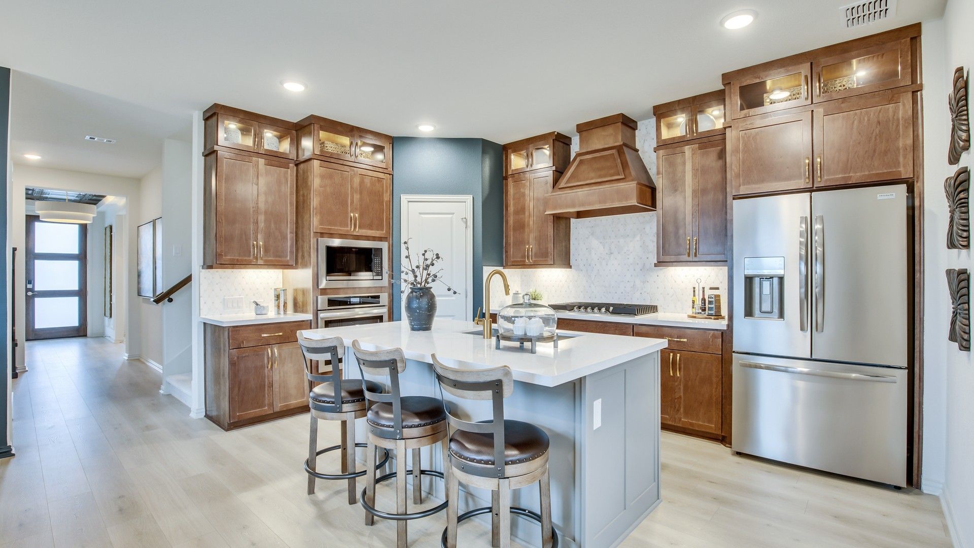 Elegant Opal Ranch kitchen features premium wood cabinetry and exquisite marble surfaces.
