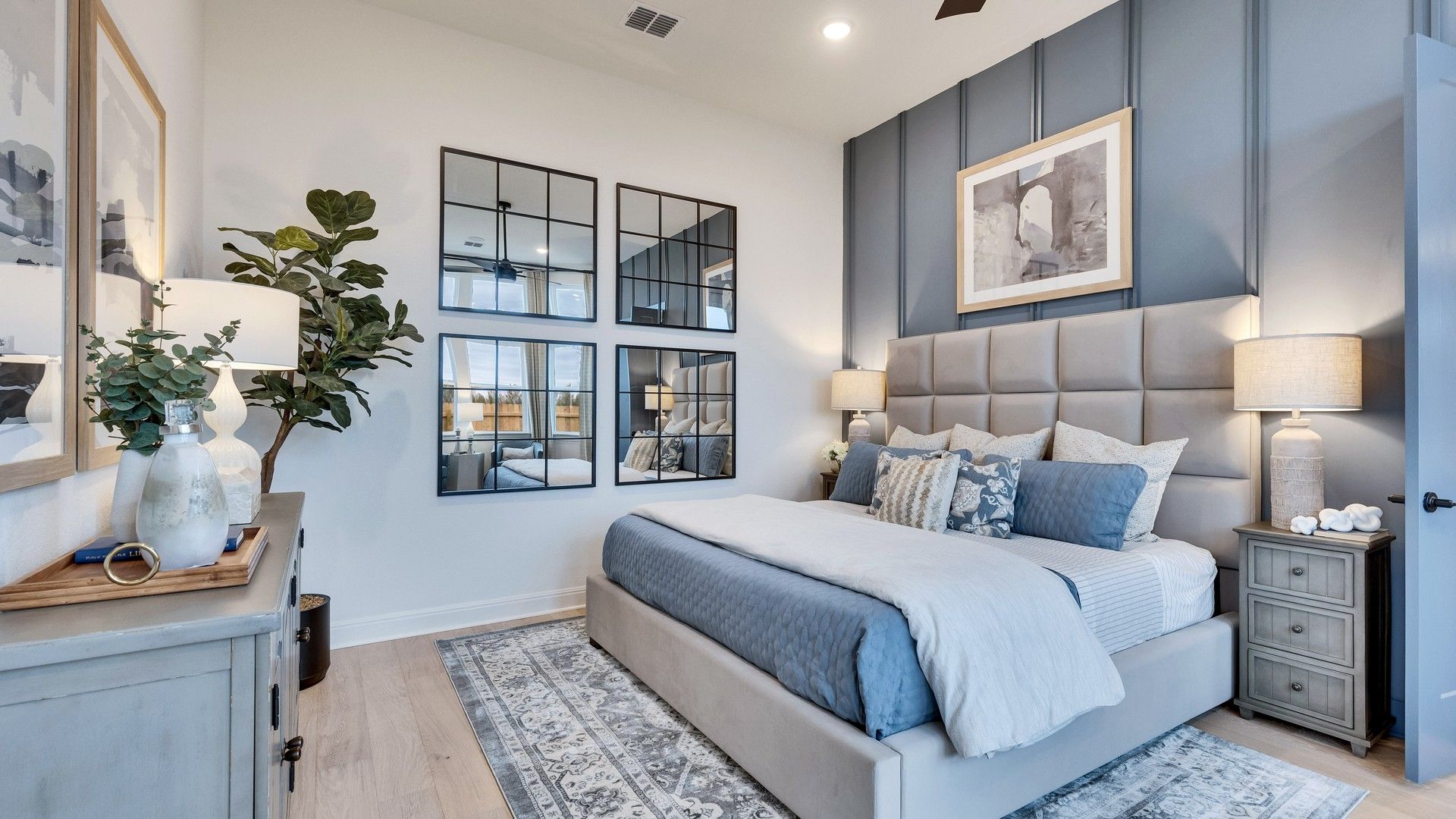 Experience luxury with a tufted headboard, mirrored accents, and rich paneling in Spring Creek.