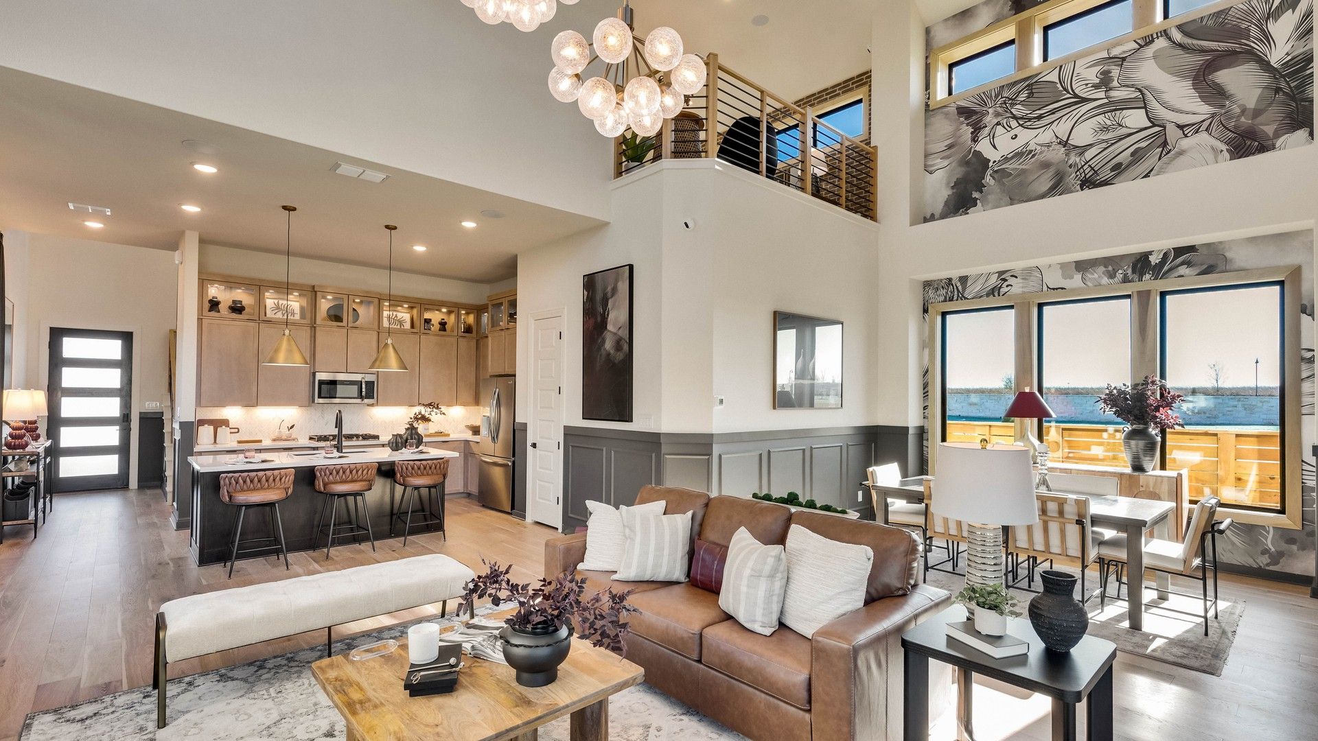 Revel in high ceilings and elegant lighting in this Flora community home’s luxurious open-concept design.