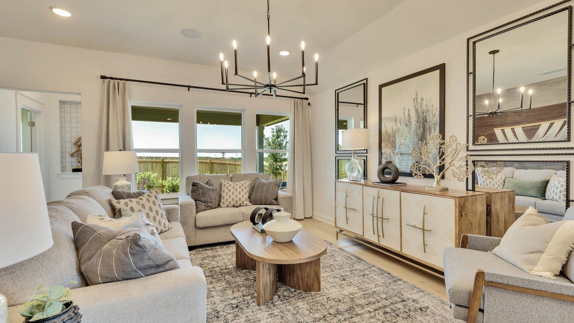 Bright living room adorned with sleek chandelier and chic furnishings in Hunters Glen.