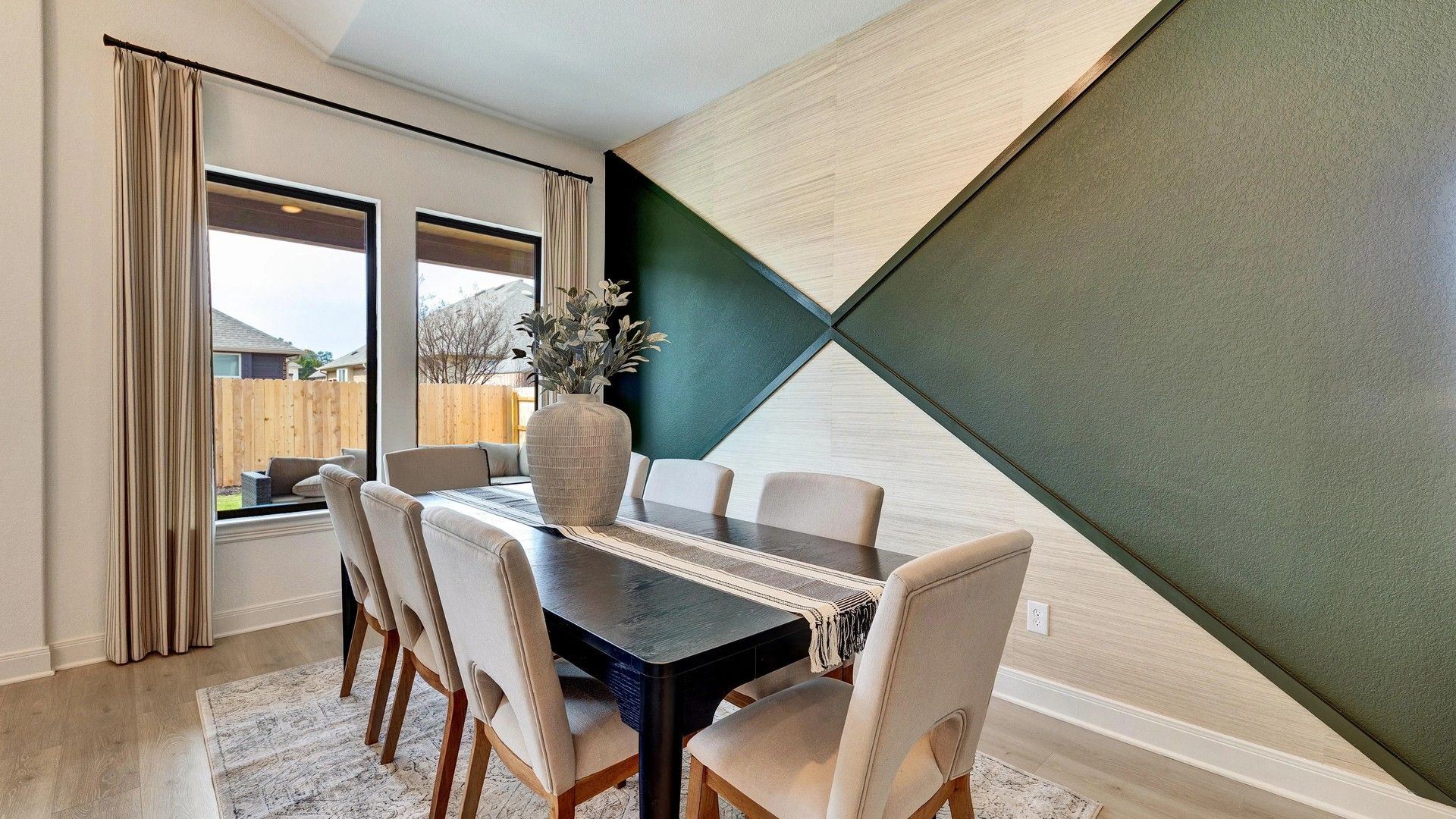 Experience luxury at Hawkes Landing with modern geometric wall paneling and expansive windows.