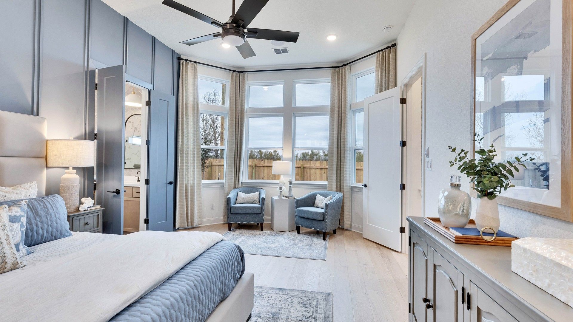 Discover tranquility in this Spring Creek bedroom with exquisite bay windows and serene blue accents.