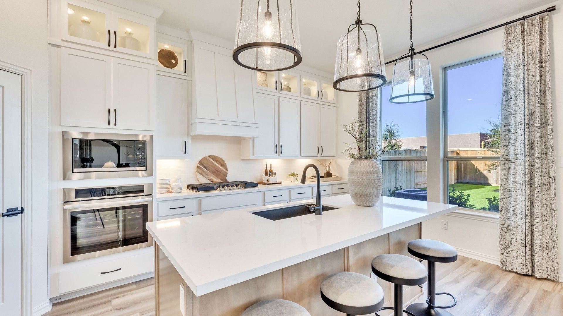 Luxurious Briarwood kitchen boasts elegant quartz counters, bespoke cabinetry, and designer pendant lighting.