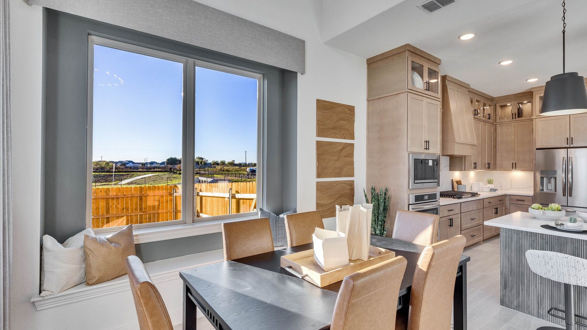 Elegant wood cabinetry and expansive window seating enhance this Creeks Crossing home.